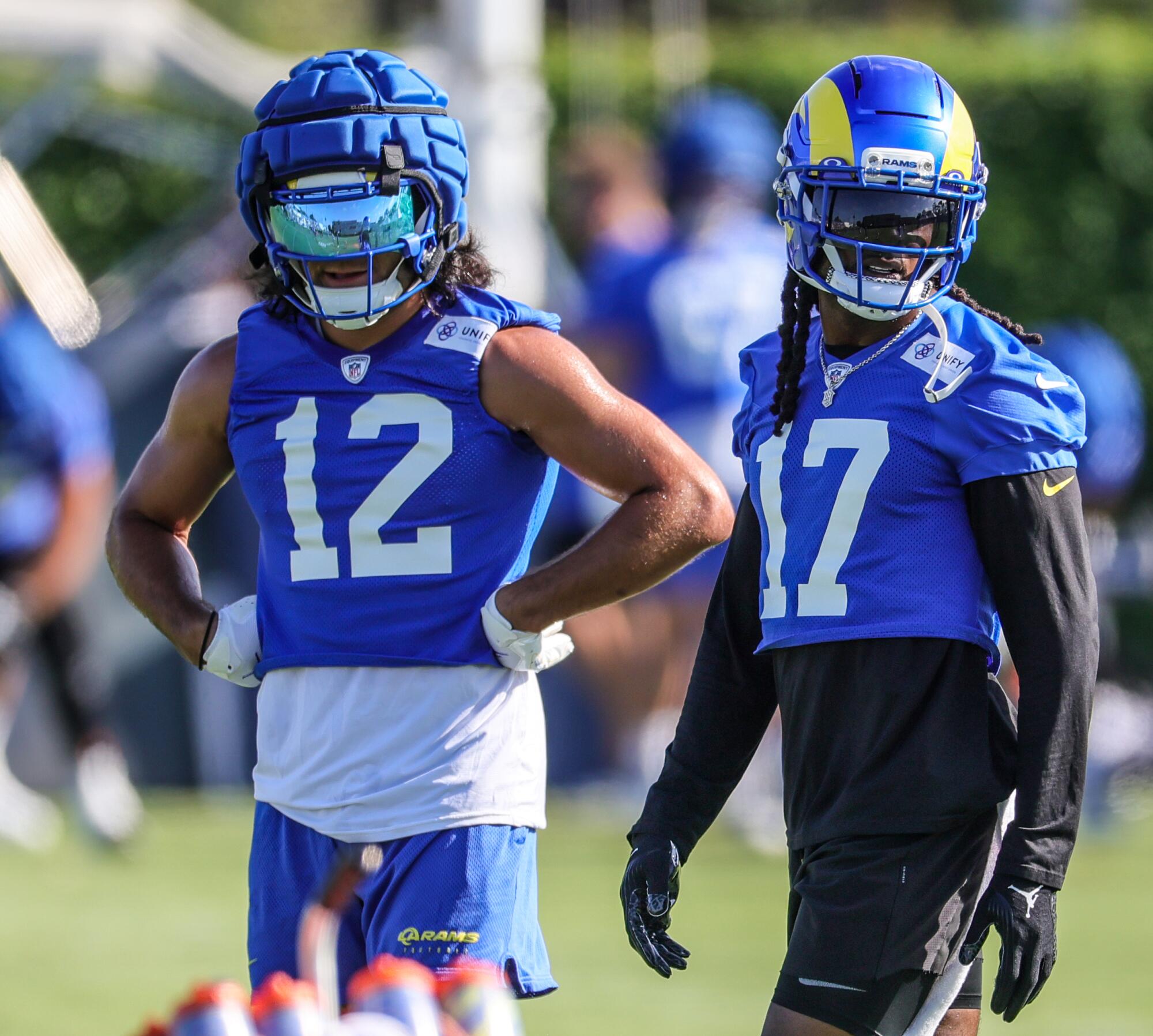 Rams receivers Puka Nacua, left, and Davante Adams prepare for a drill during training camp on Wednesday.
