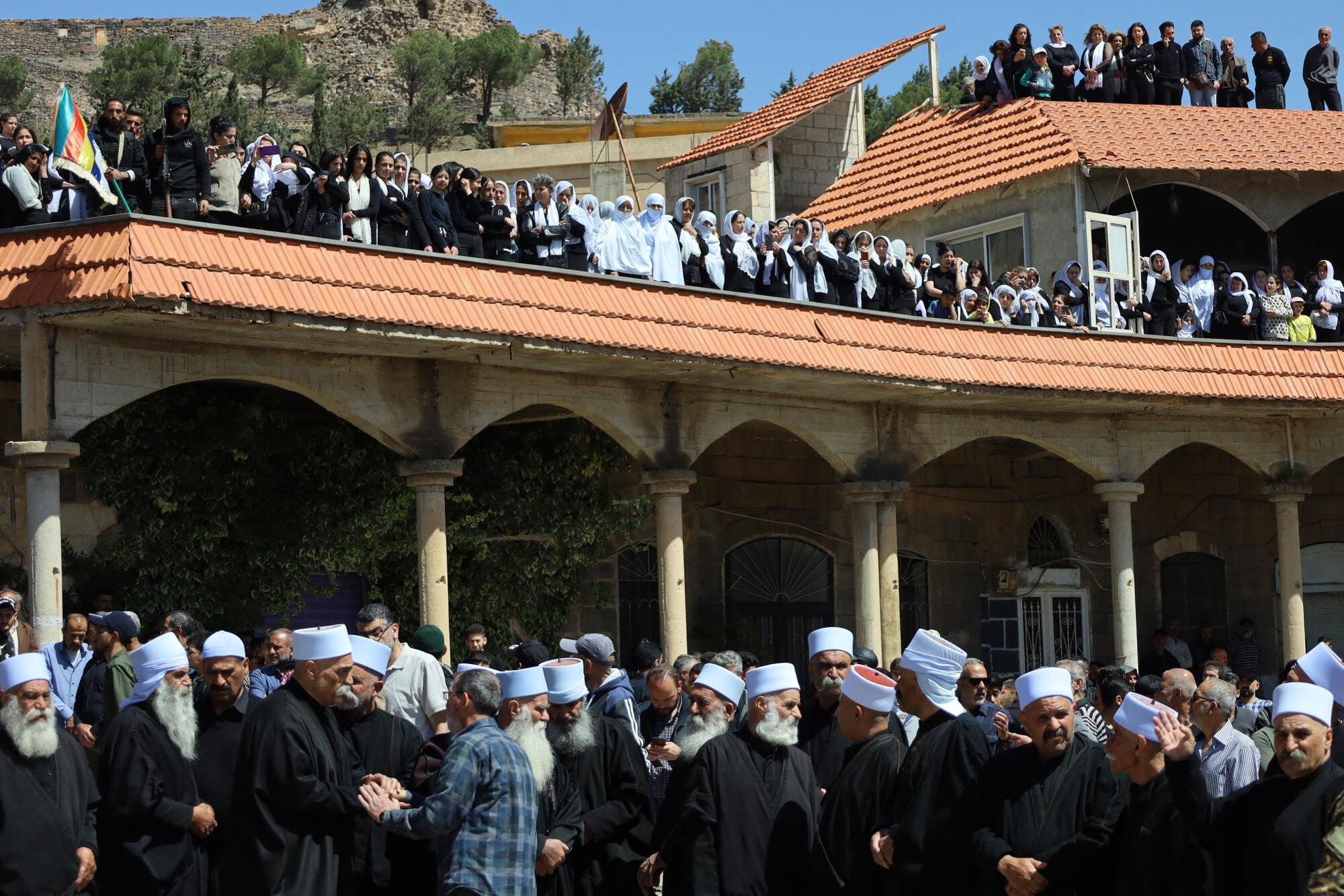 Members of Syria's Druze community attend a funeral for its members who were killed in recent sectarian clashes