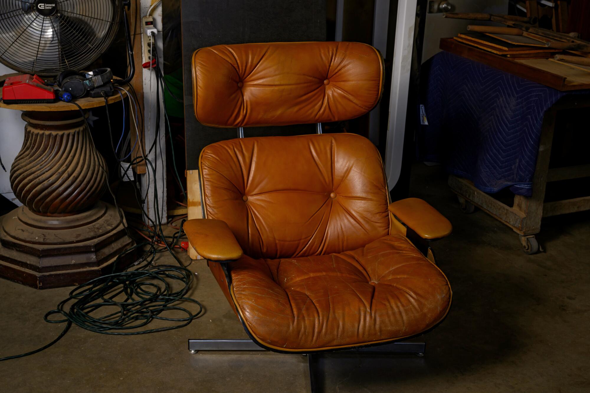 A brown leather chair and other items in Moore's space.
