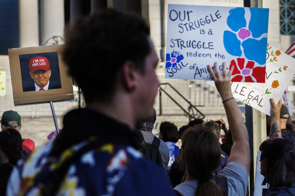 Protesters gather in front of City Hall to denounce the Trump administration