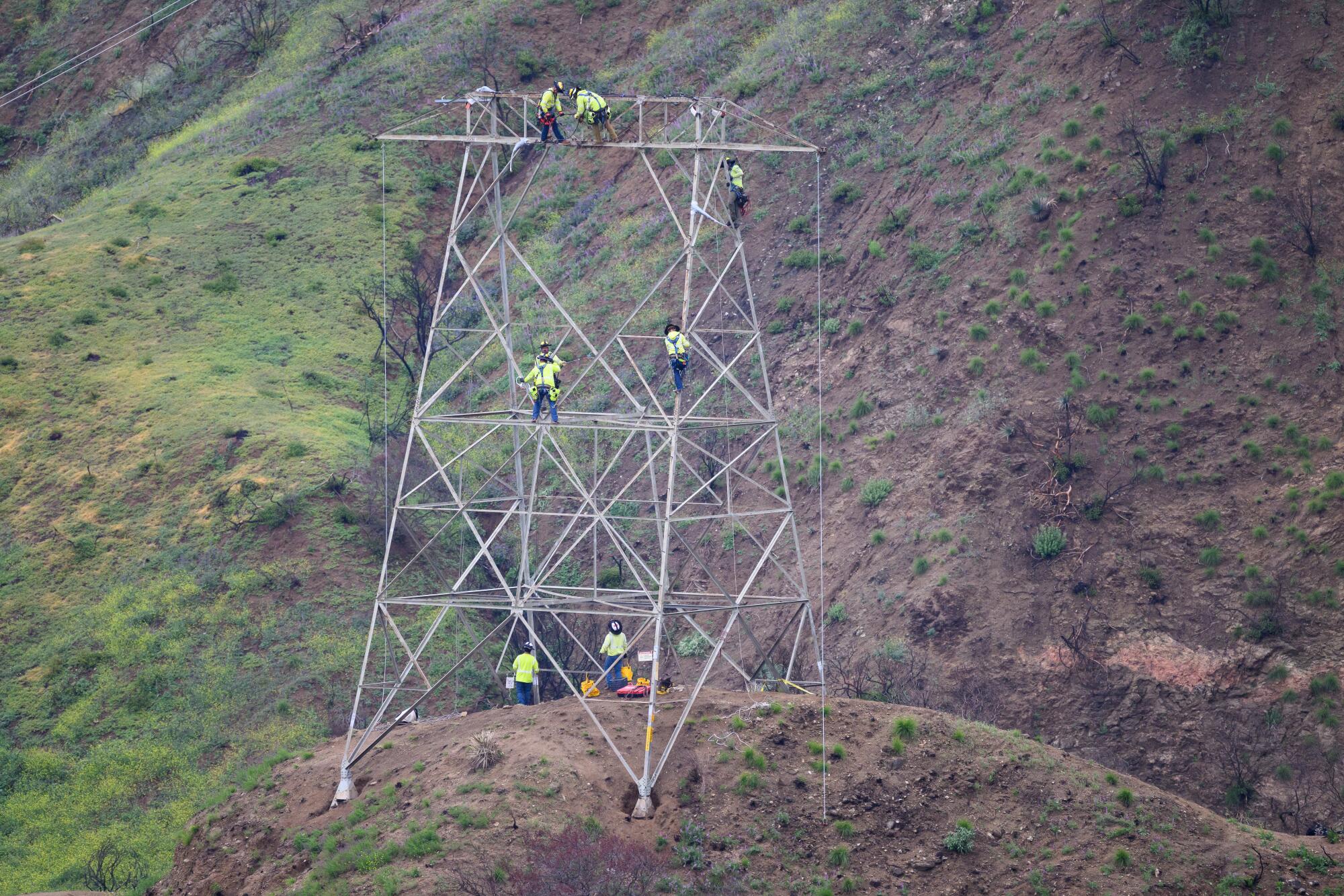 Workers inspect and prepare for the process of removing a Southern California Edison's tower in Pasadena.