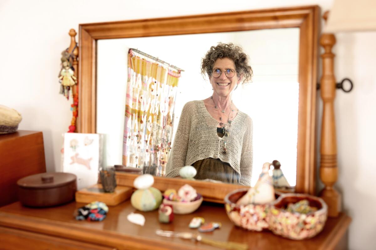 Debra Weiss is reflected in a mirror in her bedroom