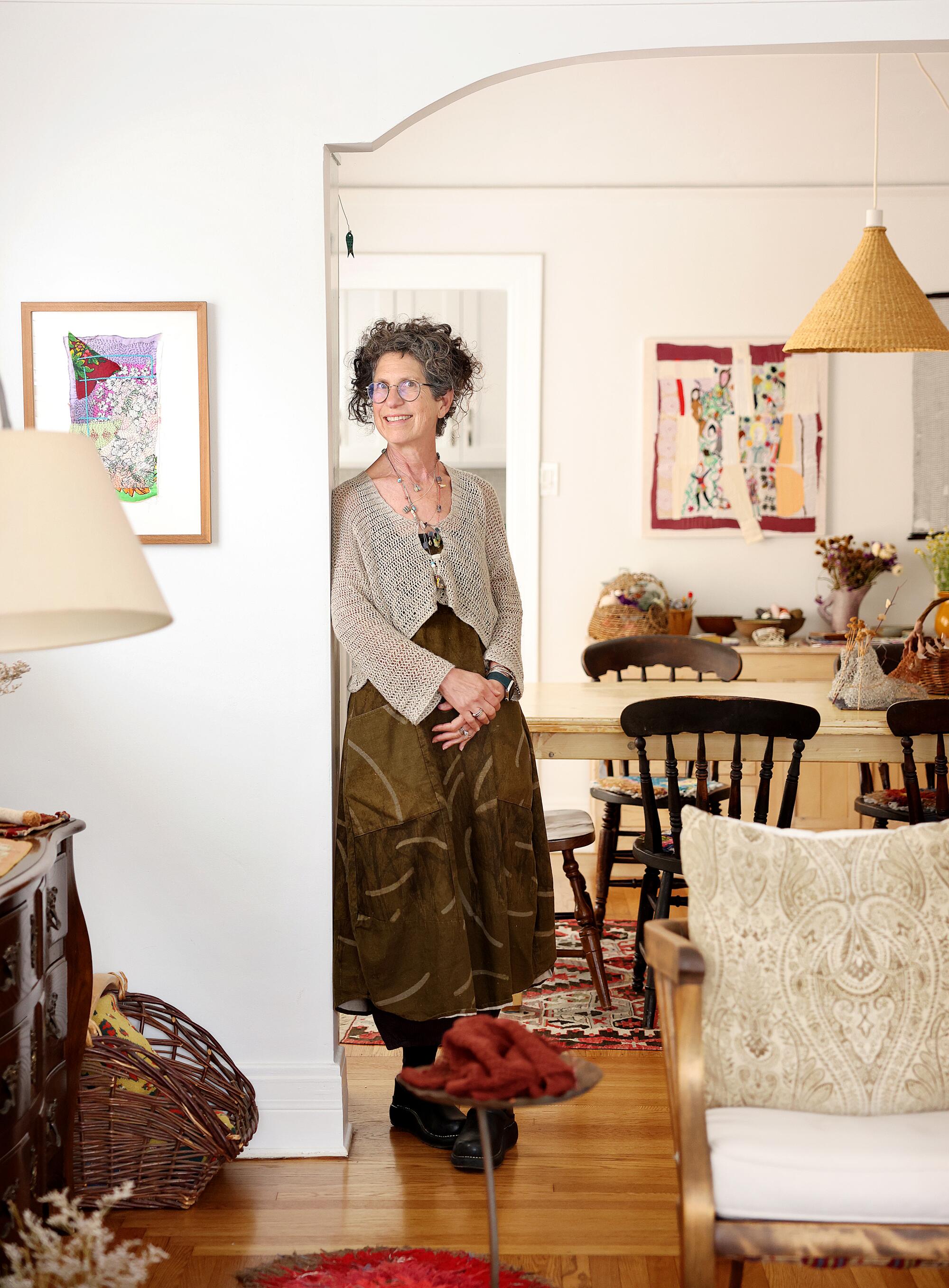 Artist Debra Weiss stands in her dining room 