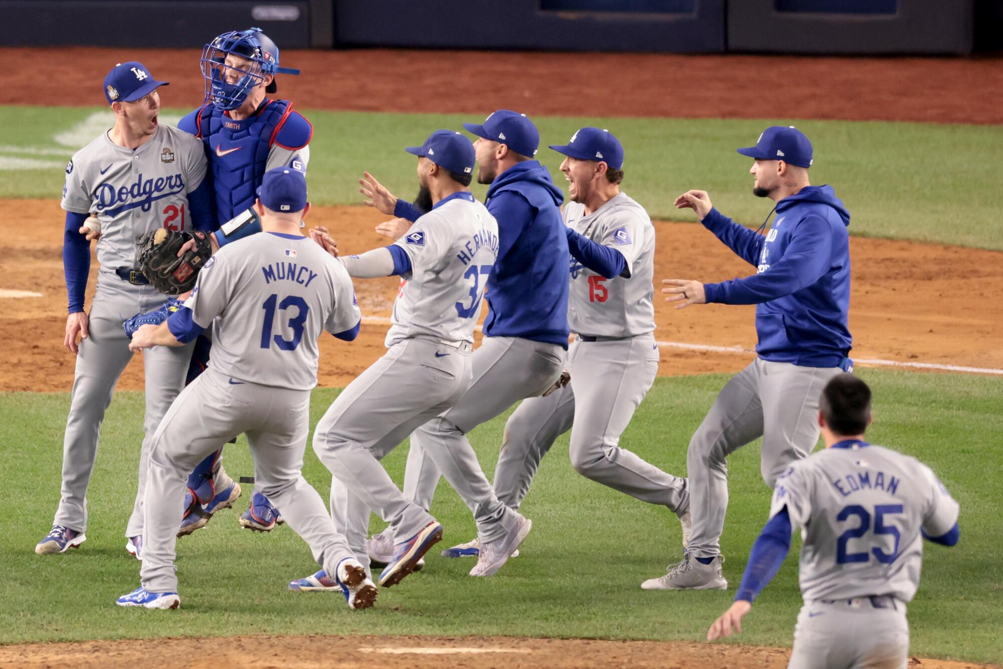 Dodgers pitcher Walker Buehler, far left, celebrates with teammates after recording the final out.