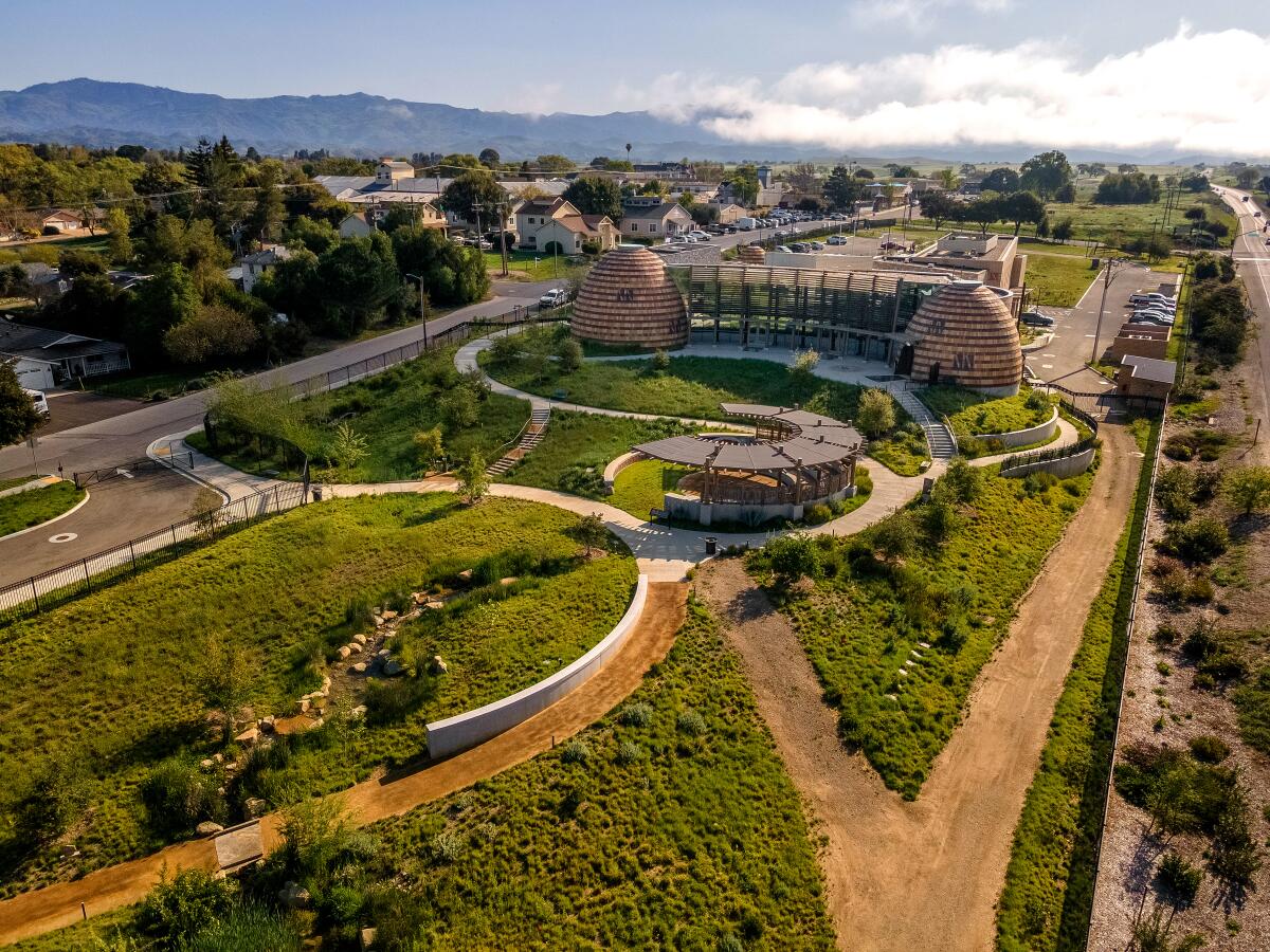 Aerial view of the green, curvy-path-lined grounds of the Sant Ynez Chumash Museum and Cultural Center. 