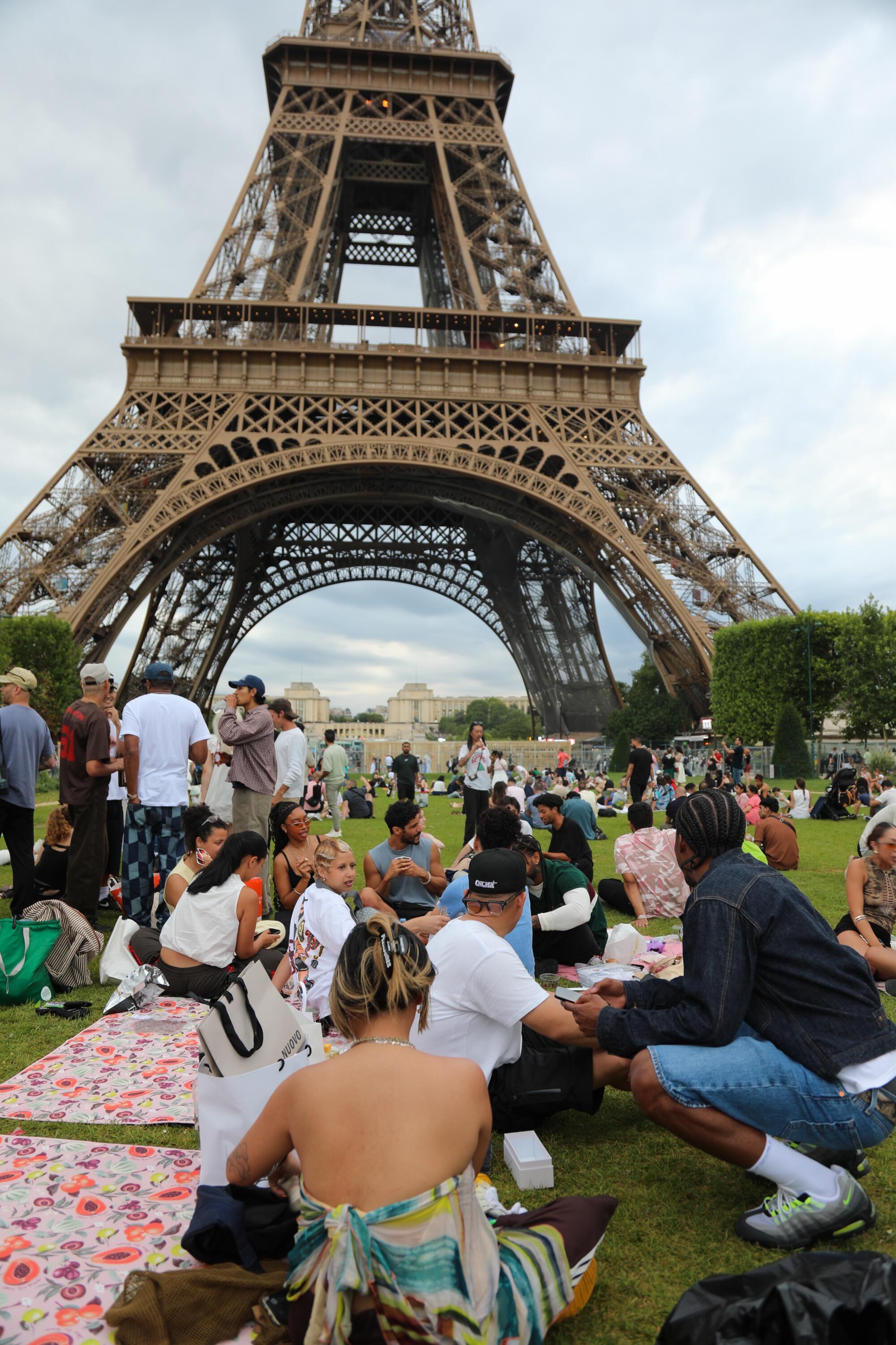 Guests attend the Courtside X Akilah Picnic at Paris Fashion Week 2025 in front of the Eiffel Tower