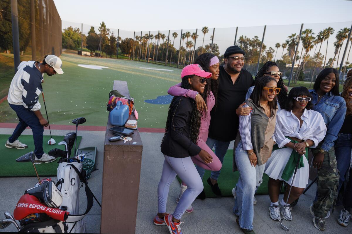 Blaise Butler of Los Angeles sets up a golf ball on the tee.