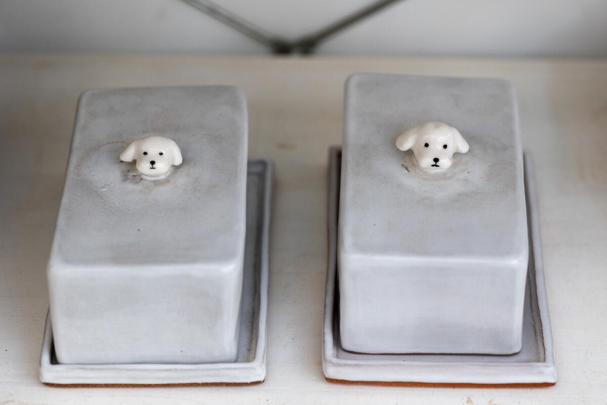 Ceramic butter dishes with the heads of Maltese dogs