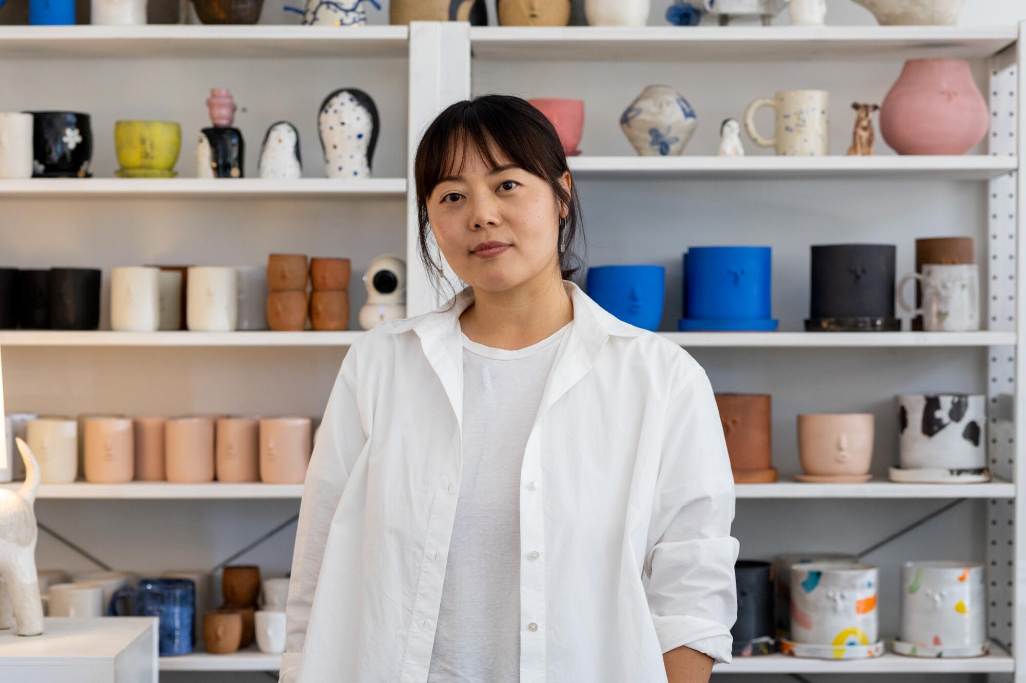 Ceramicist Rami Kim poses for a portrait at her studio 