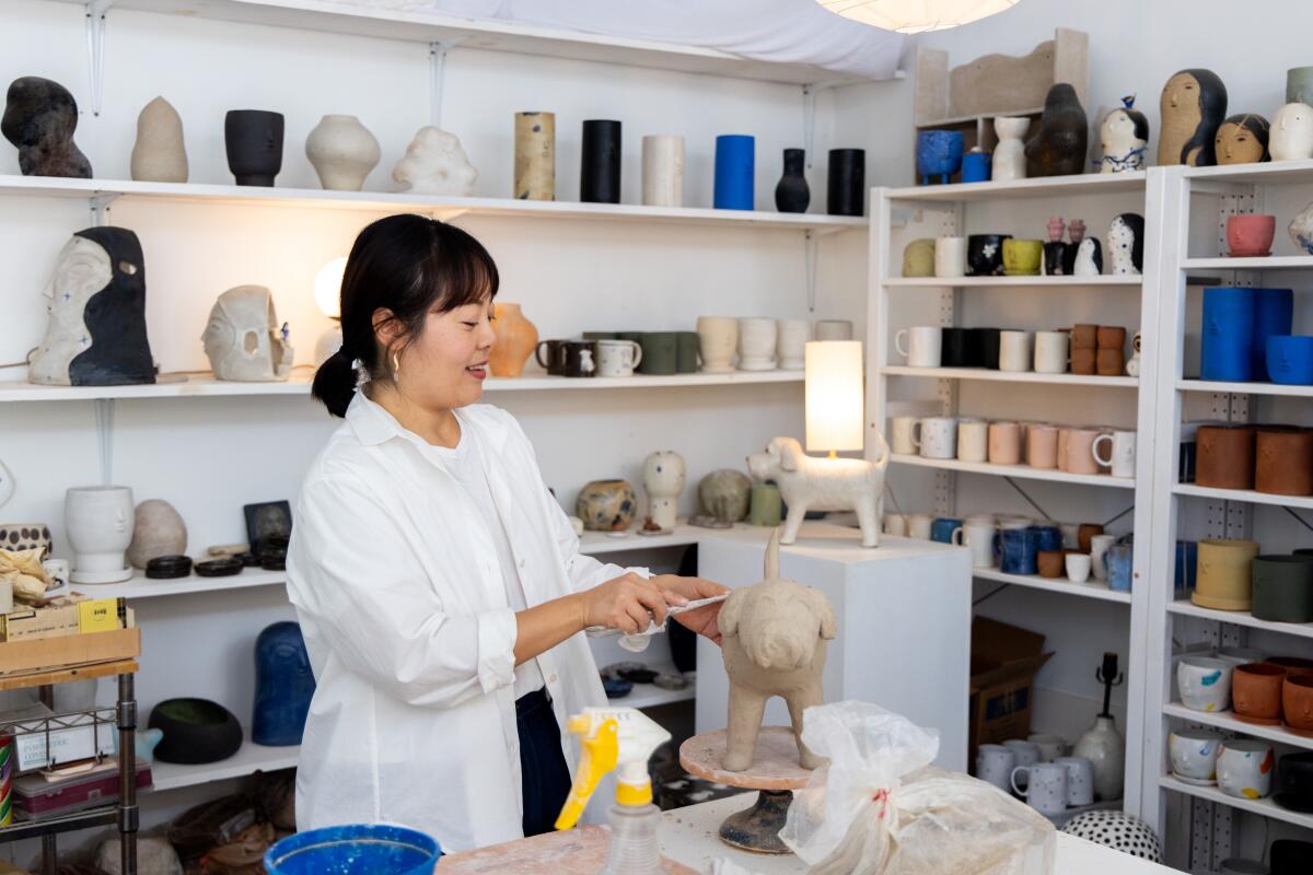 Ceramicist Rami Kim works on a sculpture of her late dog Gus