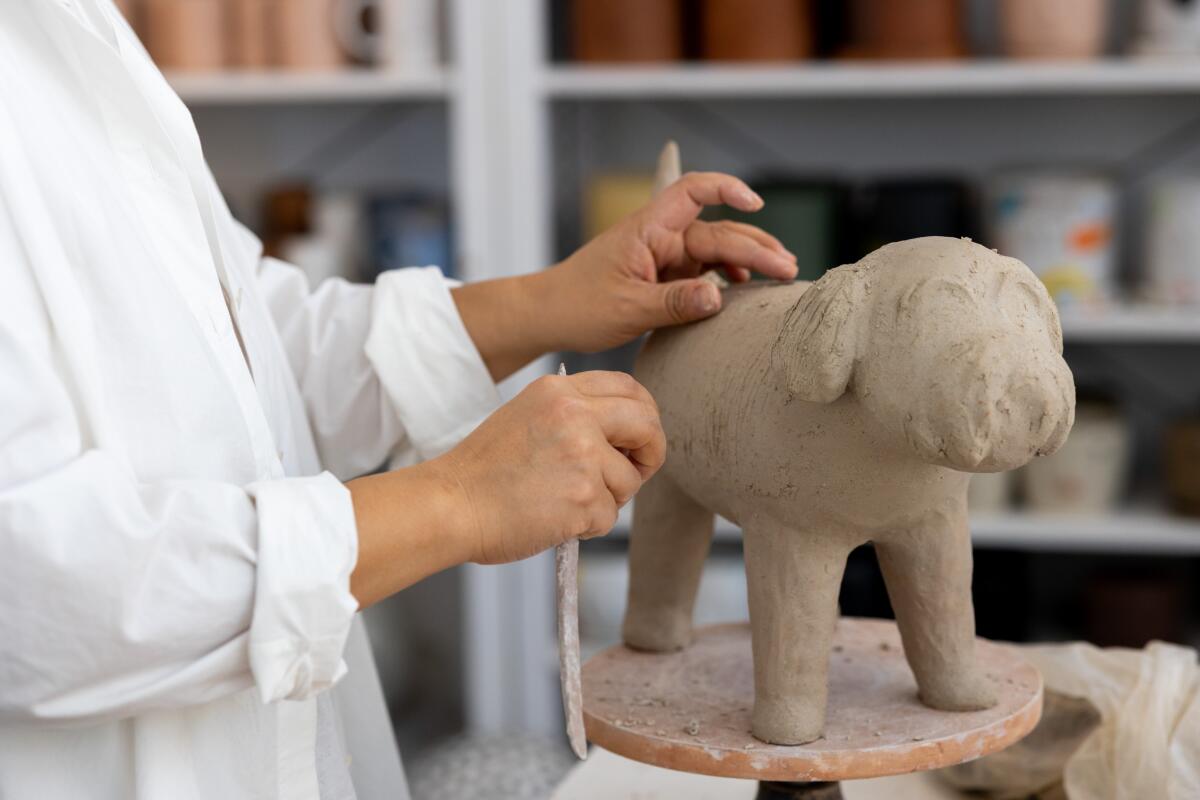 Ceramicist Rami Kim works on a sculpture of her late dog Gus 