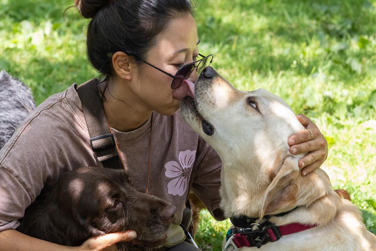Assistant trainer Soyun Ahn gets a kiss from Gus.