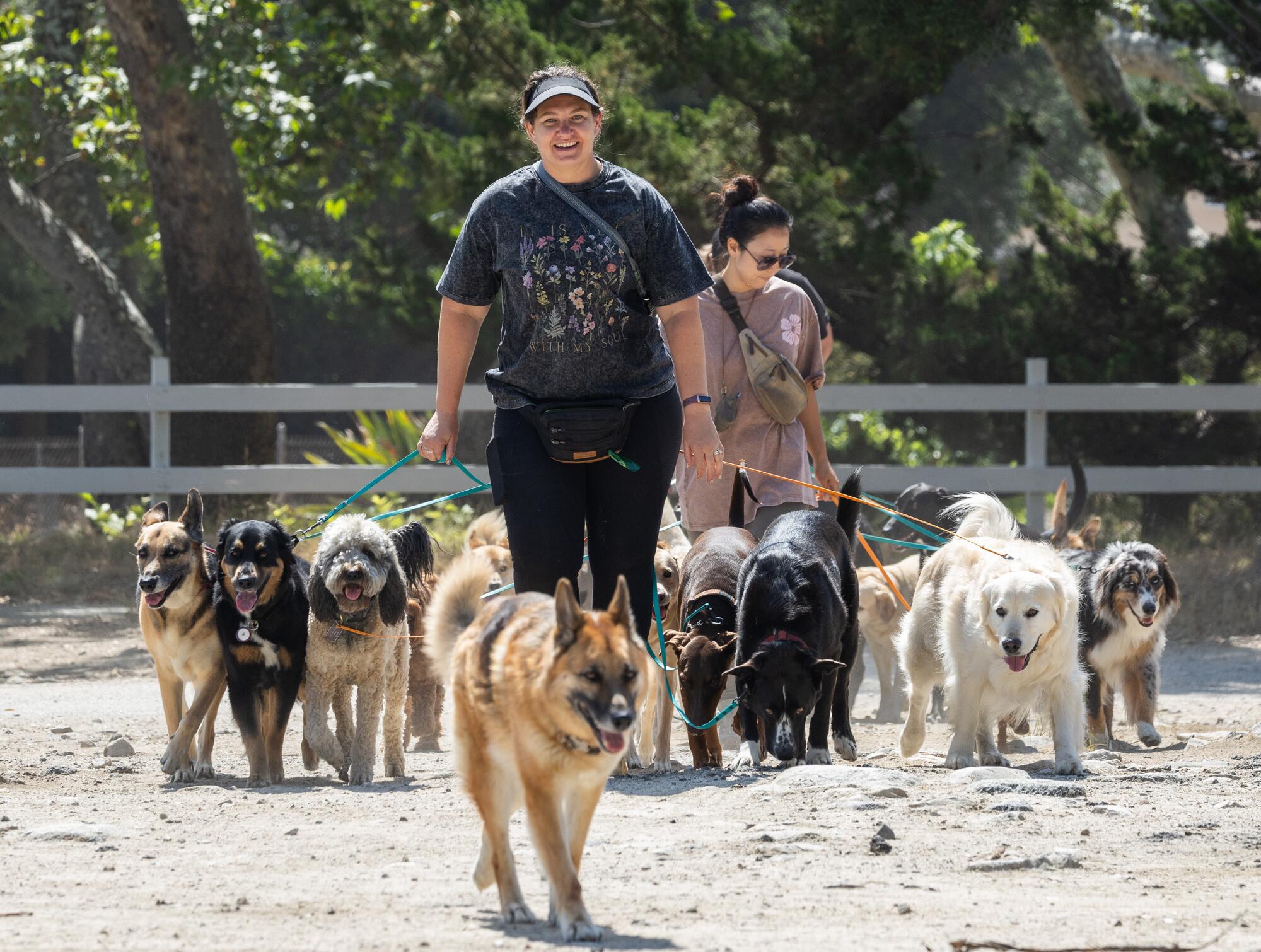 Natalie Langan, center, and husband Chase Langan are co-owners of Trailhead Hounds. 