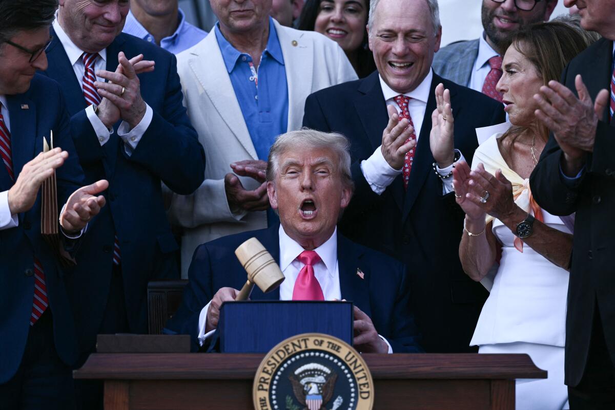 US President Donald Trump (C) holds a gavel after signing the "Big Beautiful Bill Act" at the White House on July 4, 2025. 