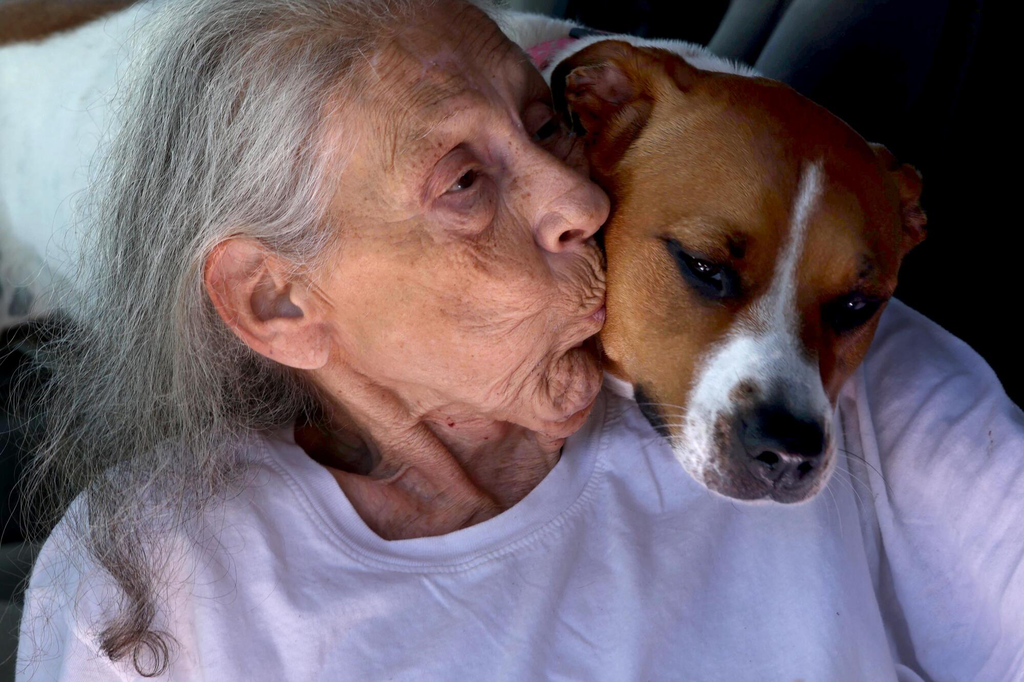 Vancie Davis gives her dog, Heart, a kiss.