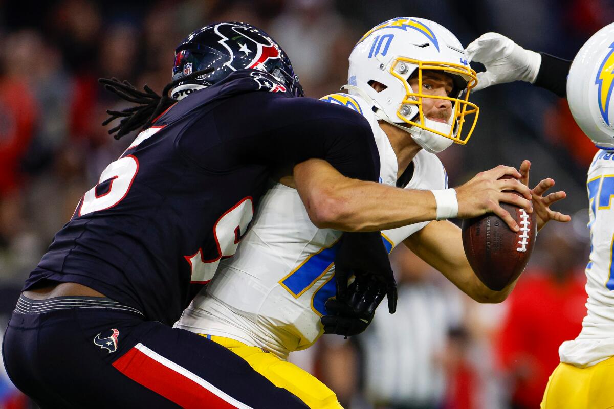 The Texans' Denico Autry sacks Chargers quarterback Justin Herbert during their AFC wild-card playoff game. 