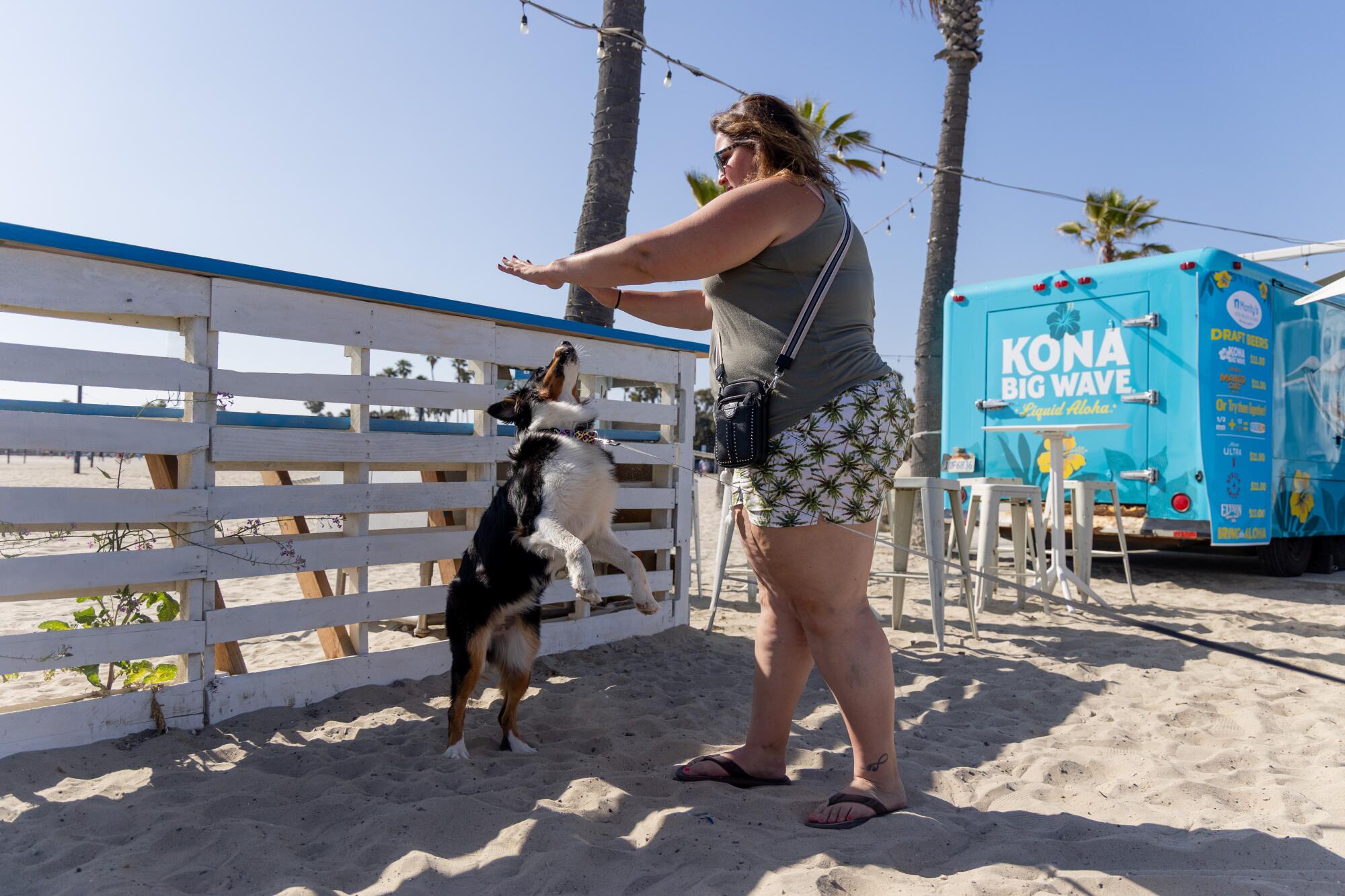 Ashley Parrish performs a trick with her dog Riley at Monty's Dog Beach & Bar.