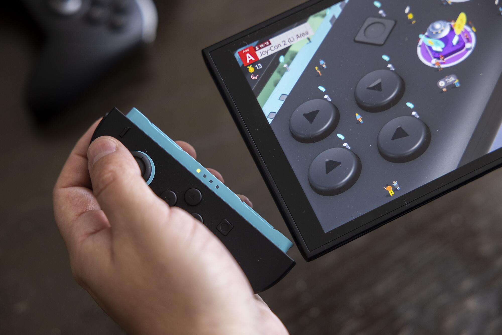 A Nintendo Switch 2 and its detached controller. 