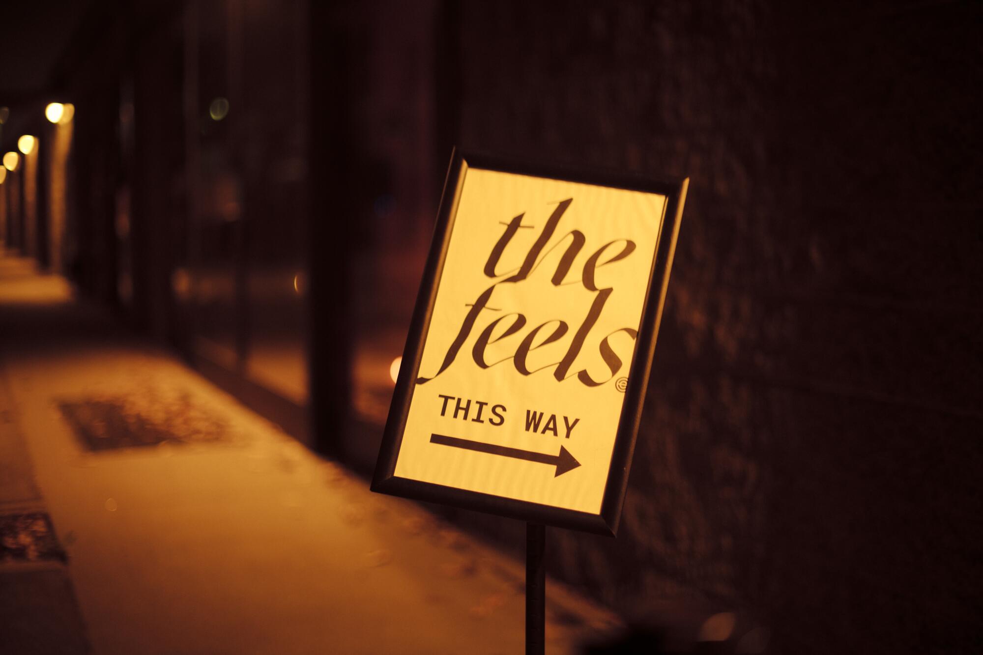 A sign directing participants to The Feels event.