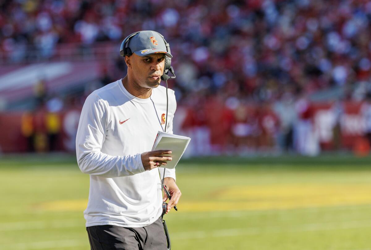 USC defensive coordinator D'Anton Lynn walks on the sideline during a game against Nebraska.