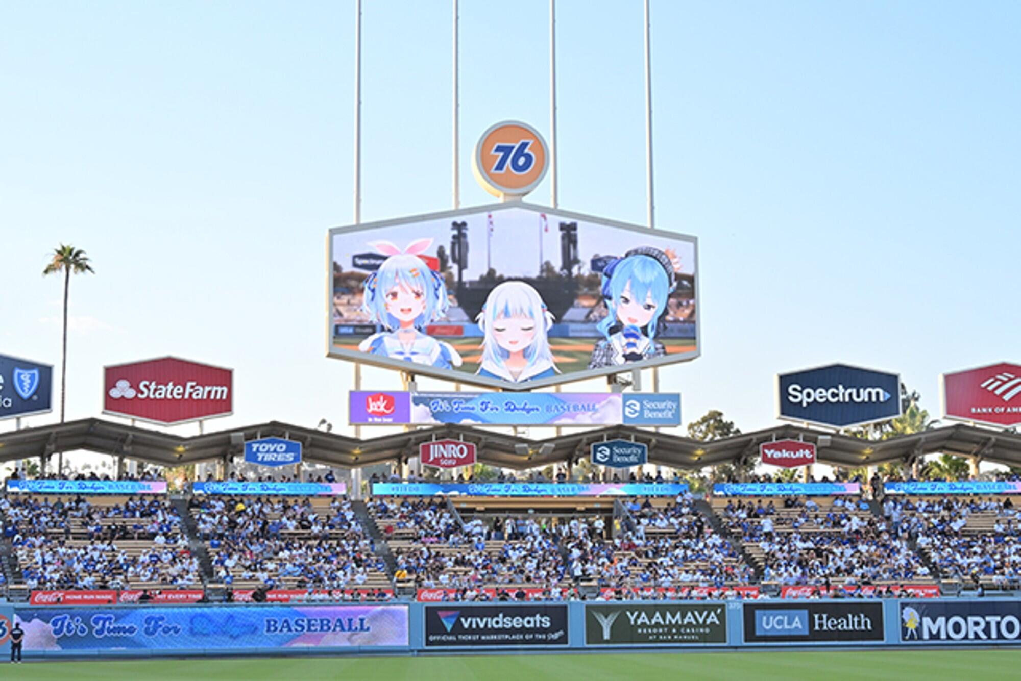 A baseball stadium scoreboard with three anime characters on it. 