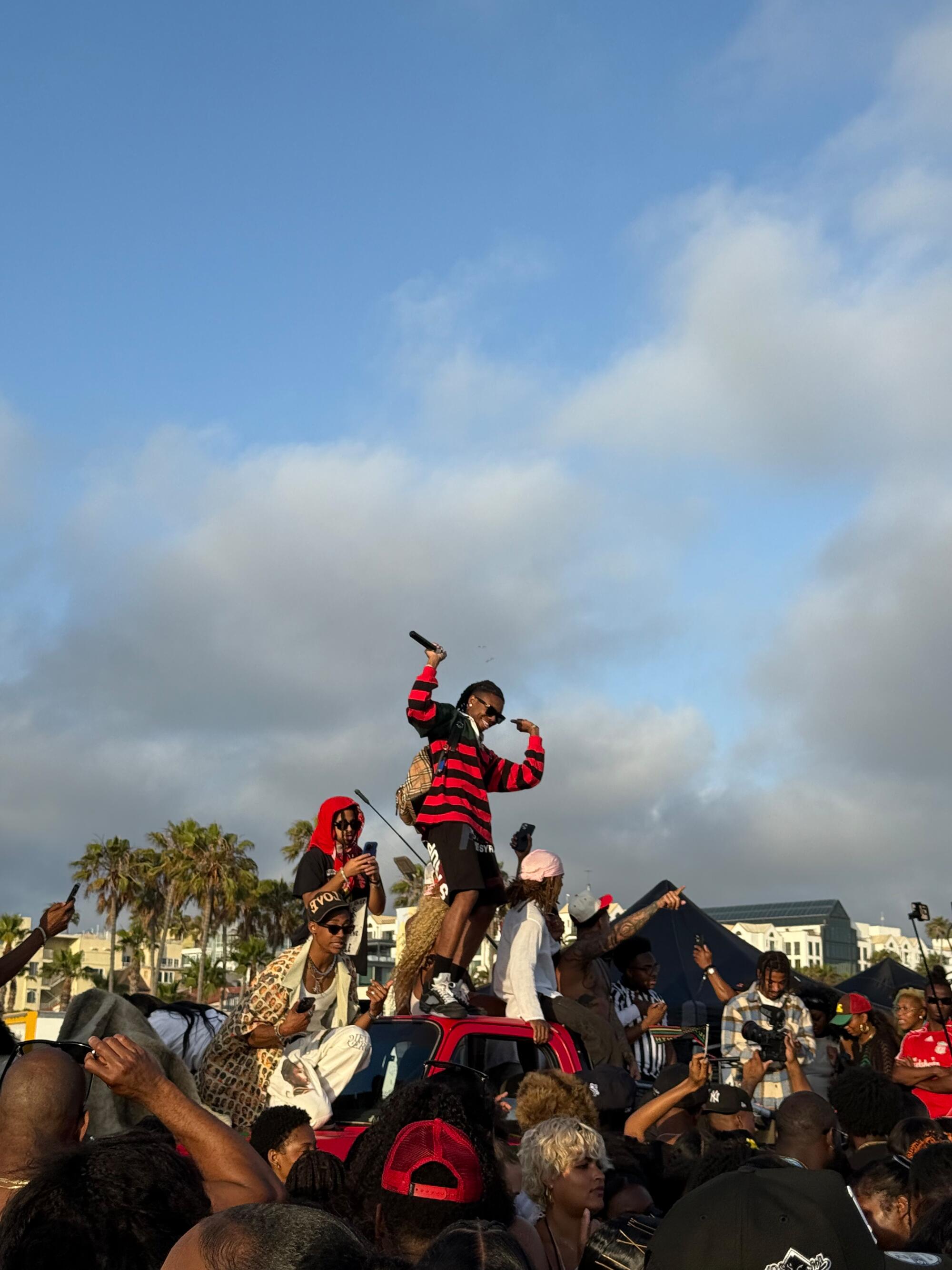 People climbed the the truck and are pictured singing atop the vehicle.