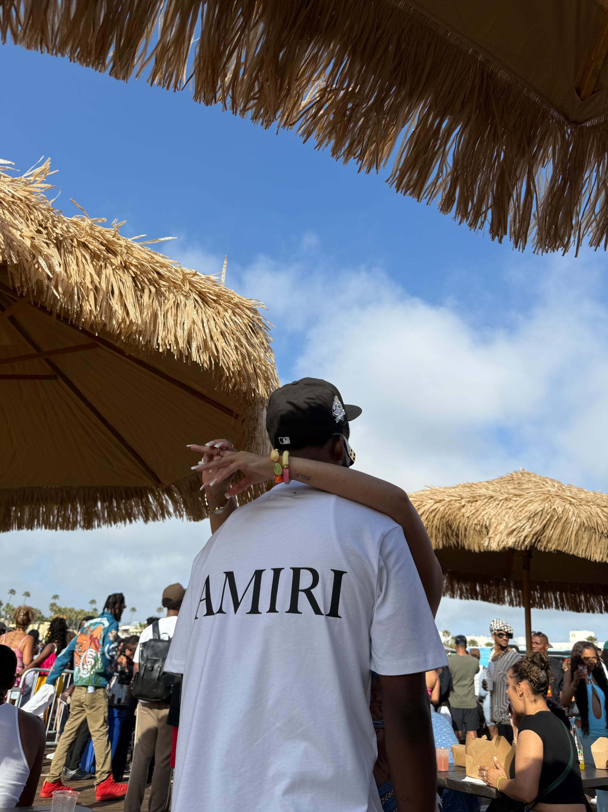 A couple embraces under umbrella.