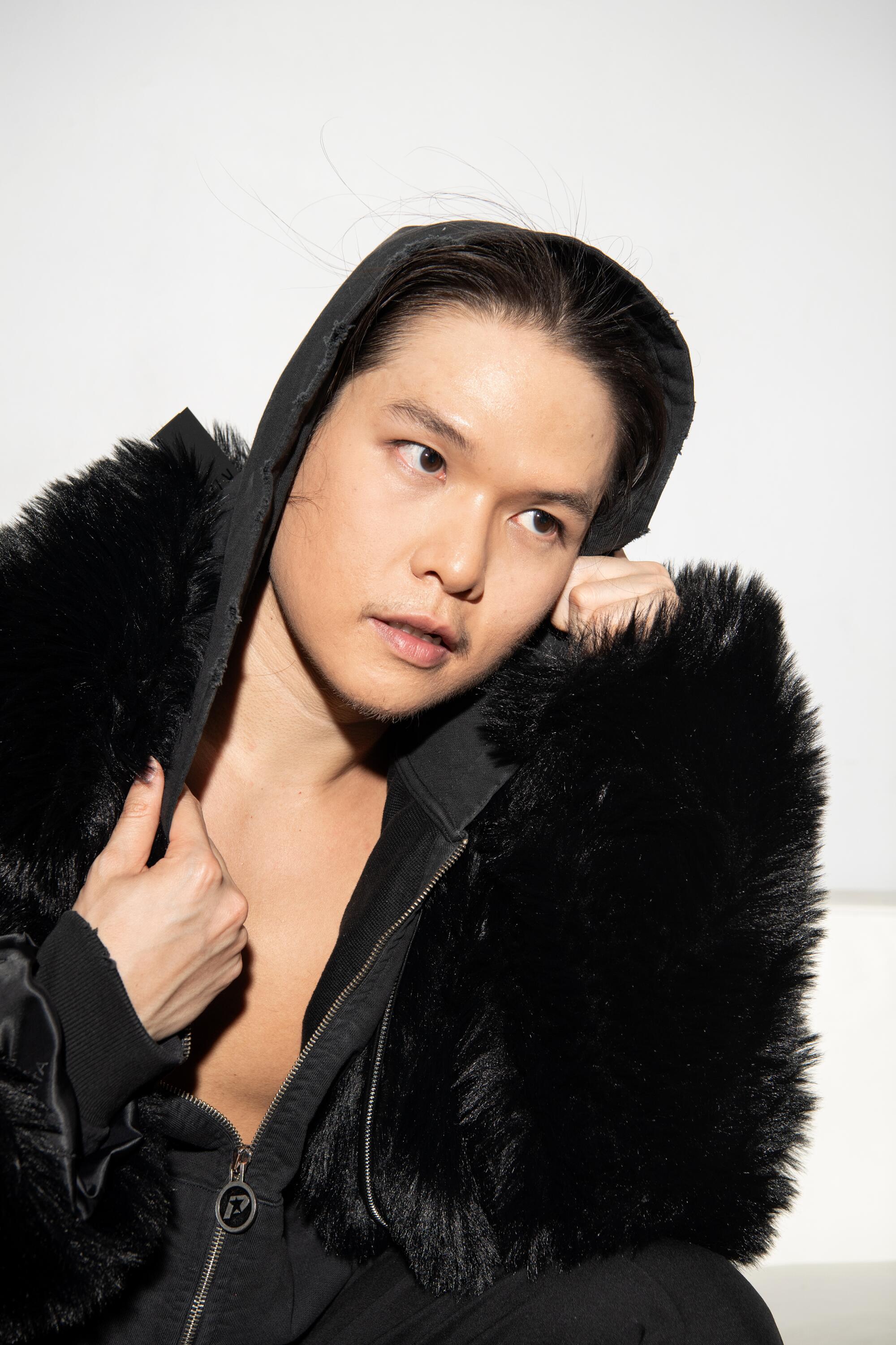 Bin wears RTA faux fur coat, BoohooMan jacket, Bottega Veneta pants, Dora Teymur boots.