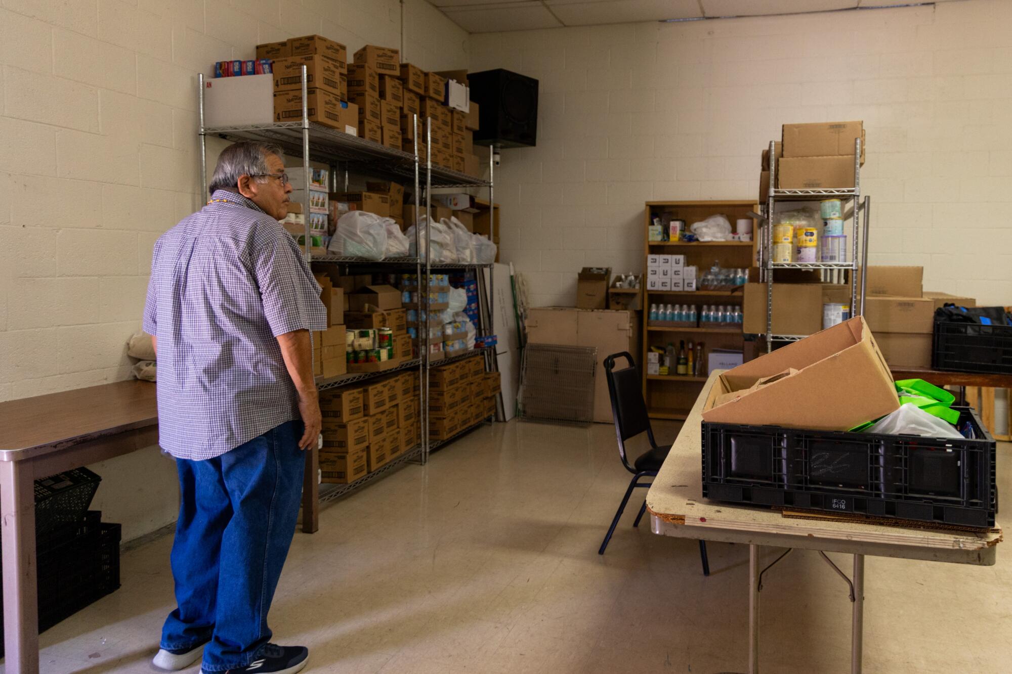 A man stands in a room with boxes.