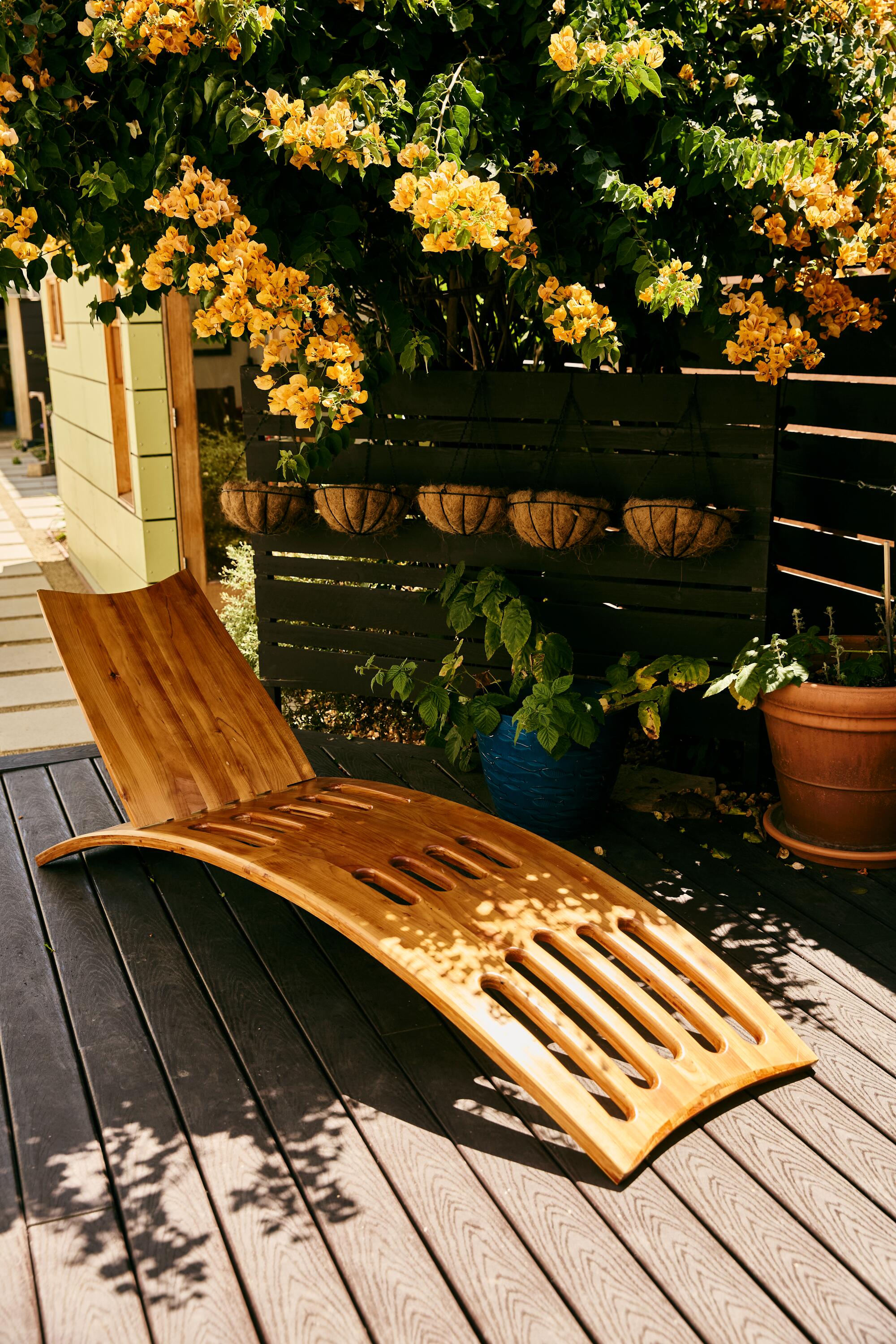 A lounge chair sits on a wooden deck.