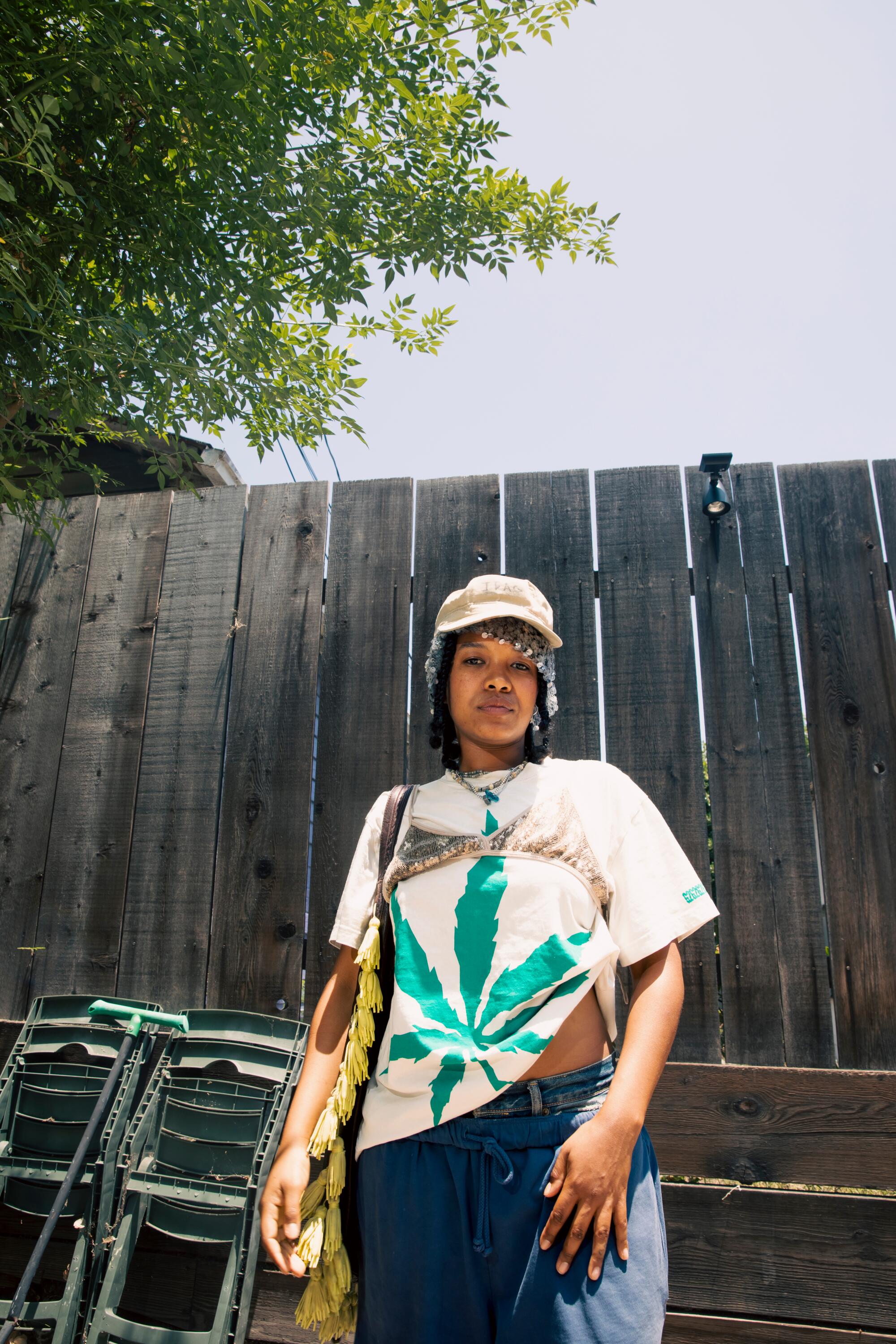 Kaamilah Thomas wears Anna Sui beanie with Dad’s army hat, Gen2 tee with Chan Luu sequin bra, Levi's jeans.