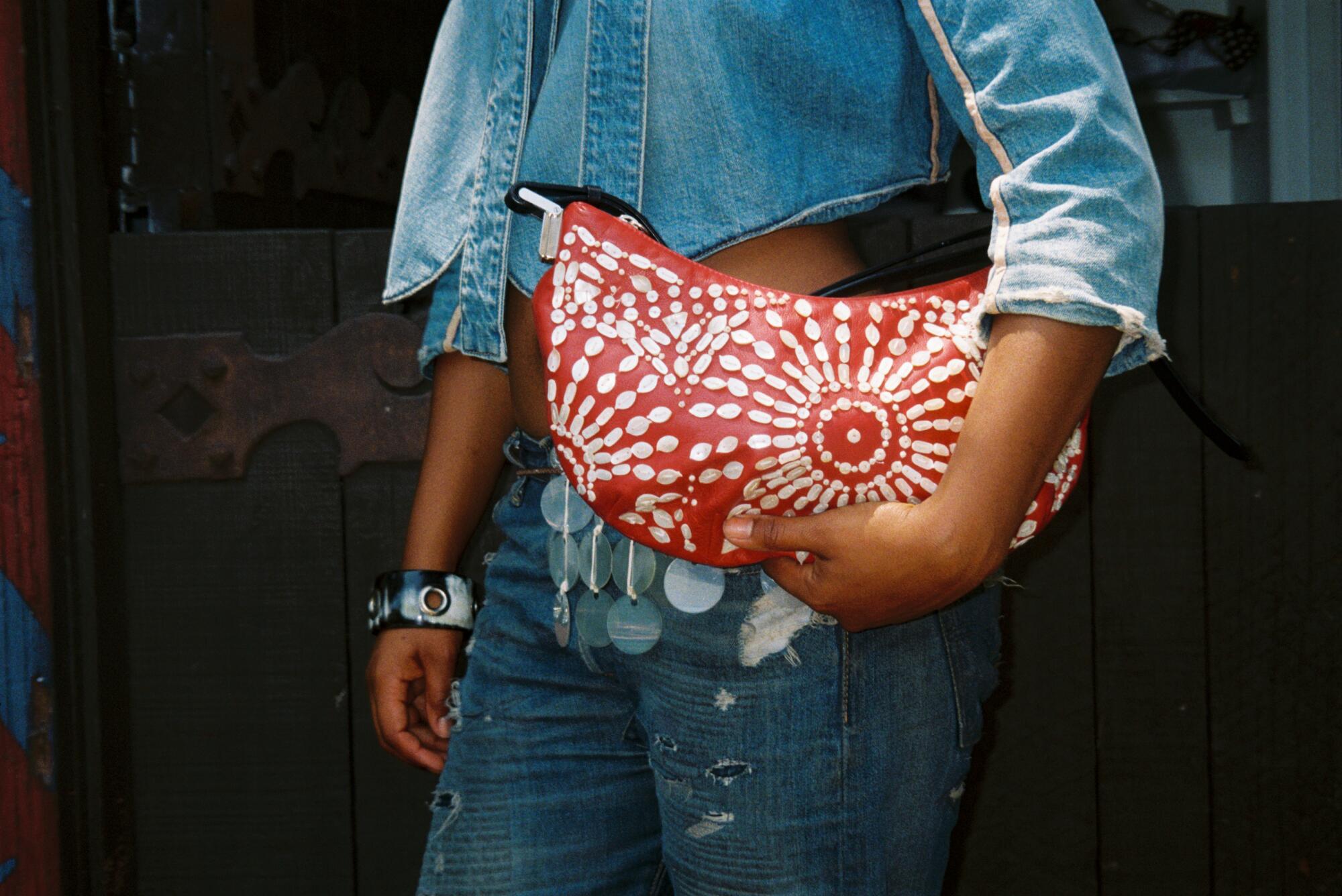 Kaamilah Thomas wears Anne Valerie Hash jacket, Levi’s bottoms, Gianfranco Ferré purse, Maryam Nassir Zadeh belt.