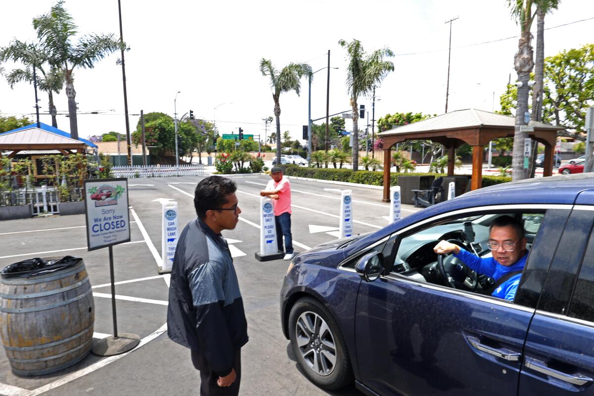 An employee of the Westchester Hand Wash tells a customer that they are closed