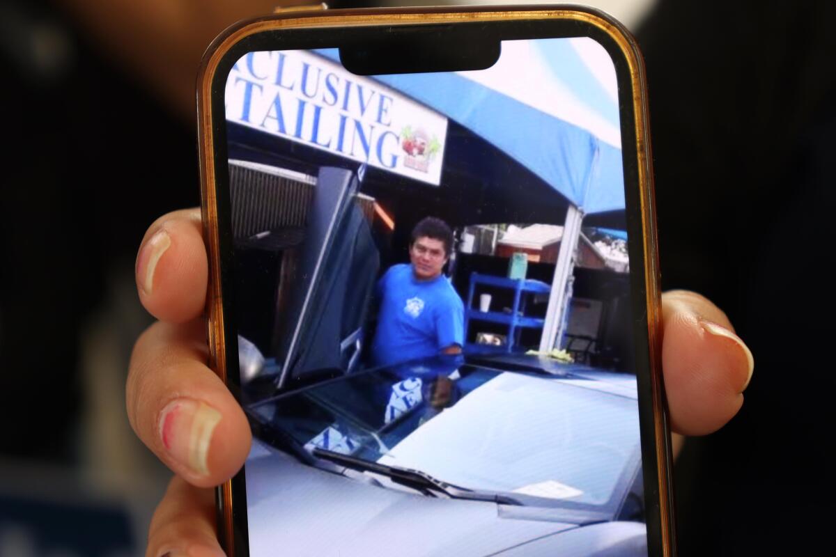 Noemi shows a photo of her husband Jesus Cruz who was taken into custody