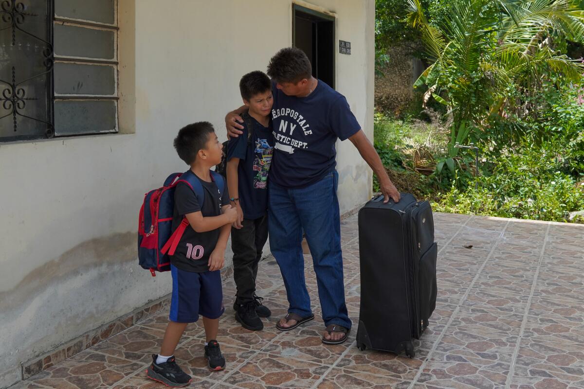 Jesus Cruz comforts his son Angel