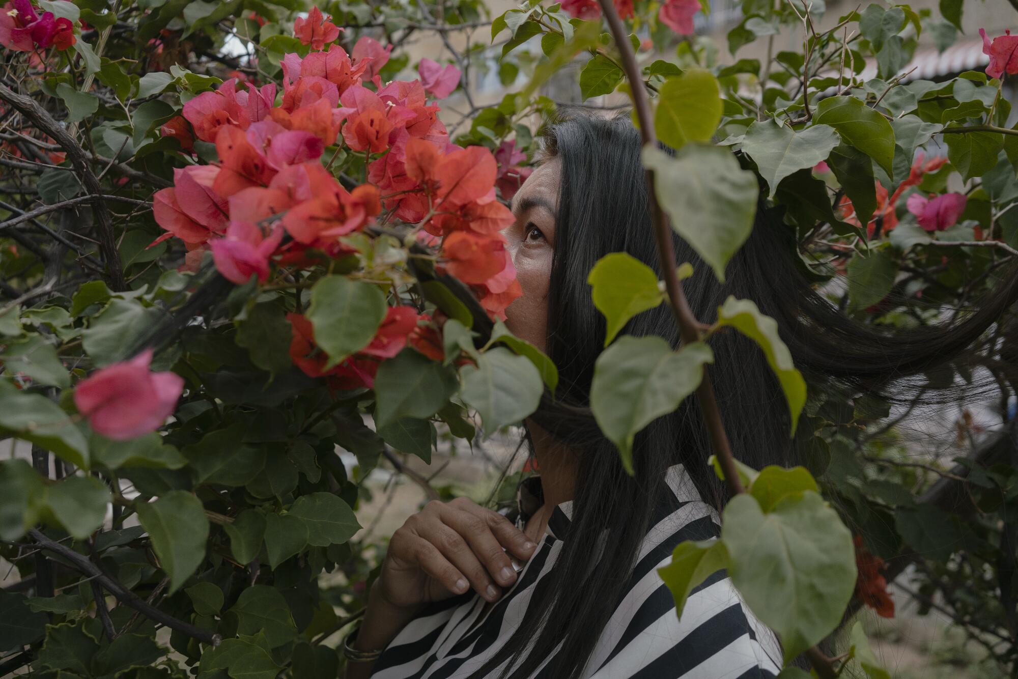 Janeth, 45, a teacher of a community school, poses for a portrait in Caracas.