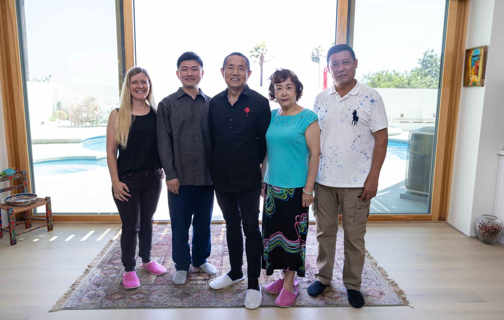 Halle Doenitz, left, De Peter Yi, Yi Kai, Zheng Jian and Larry Tan shown in a home.