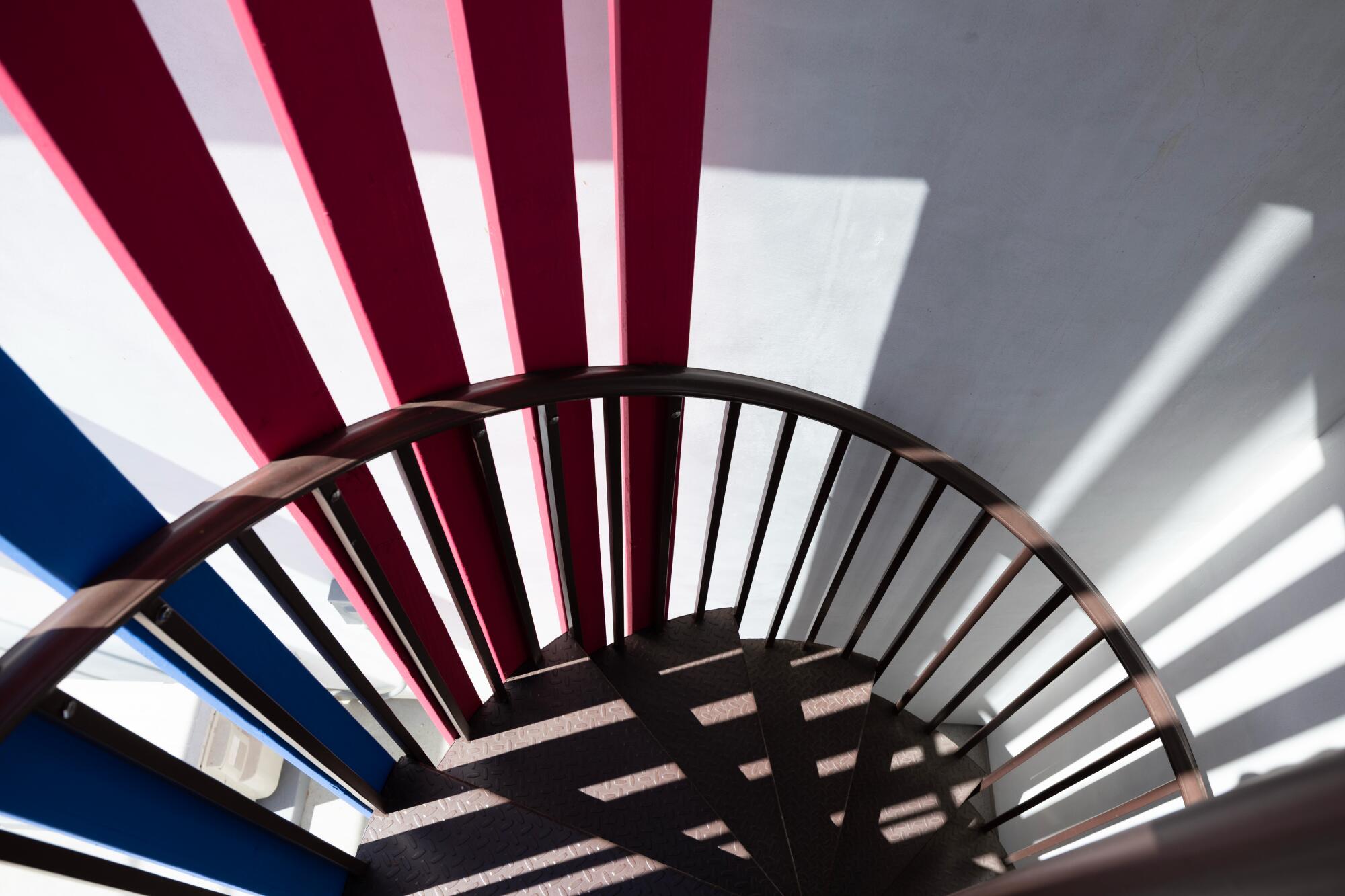 The outdoor spiral staircase painted red and blue.