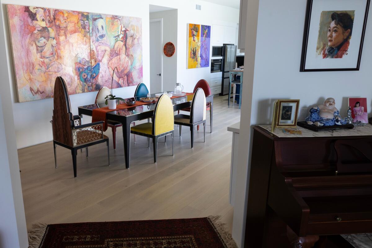 A dining room with colorful furniture and art.