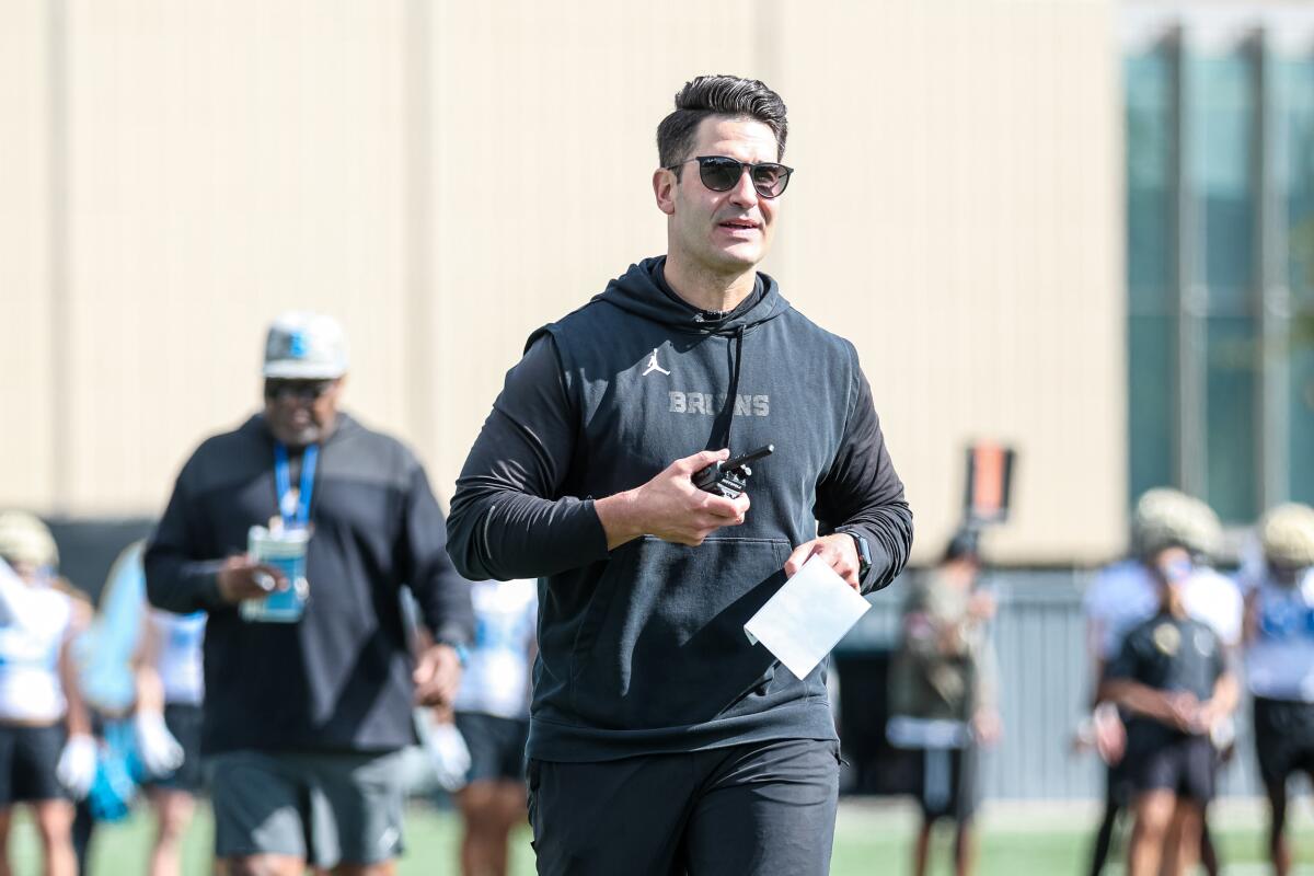 UCLA offensive coordinator and quarterbacks coach Tino Sunseri walks on the field during a spring football practice.