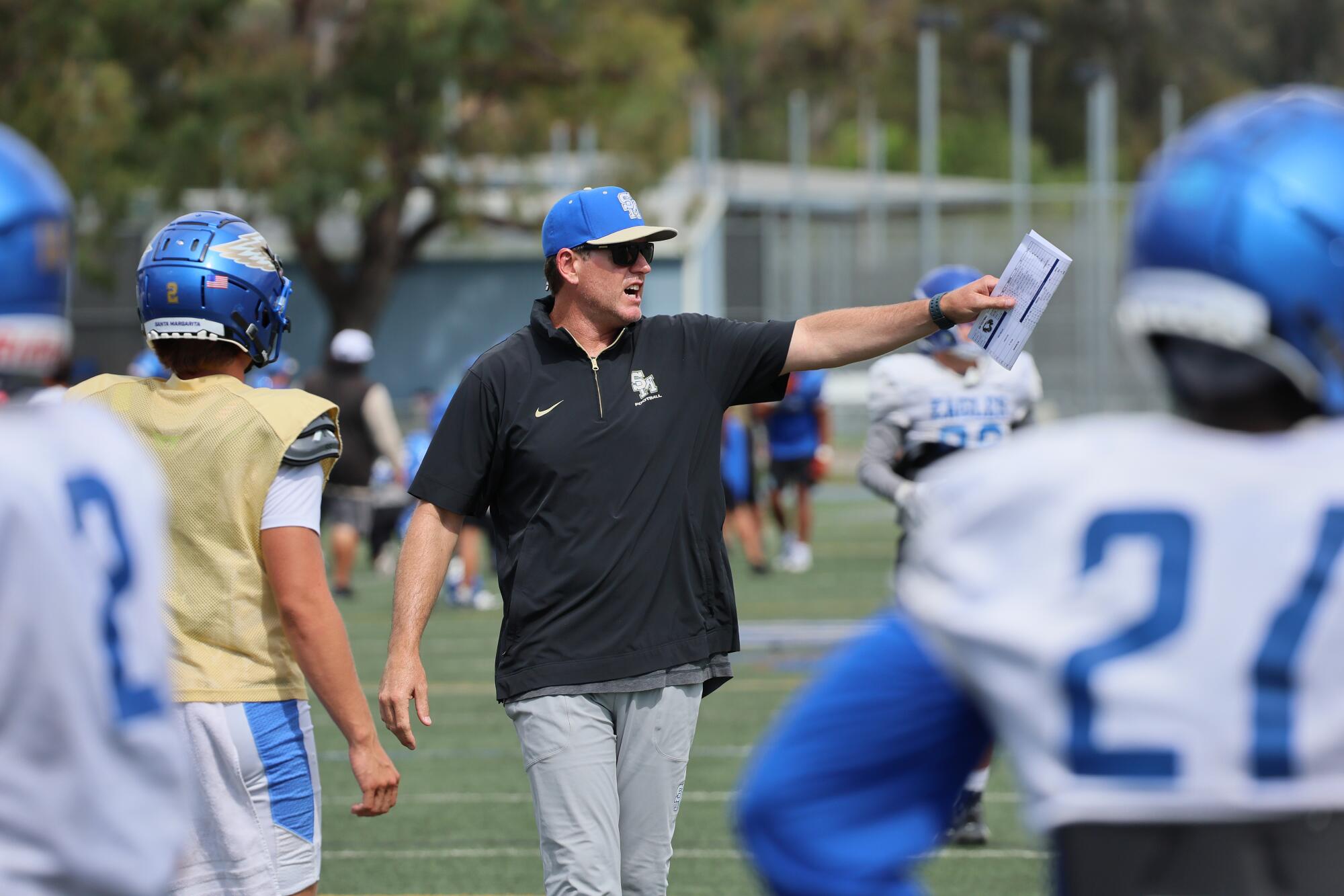 Santa Margarita coach Carson Palmer instructs his players during practice.