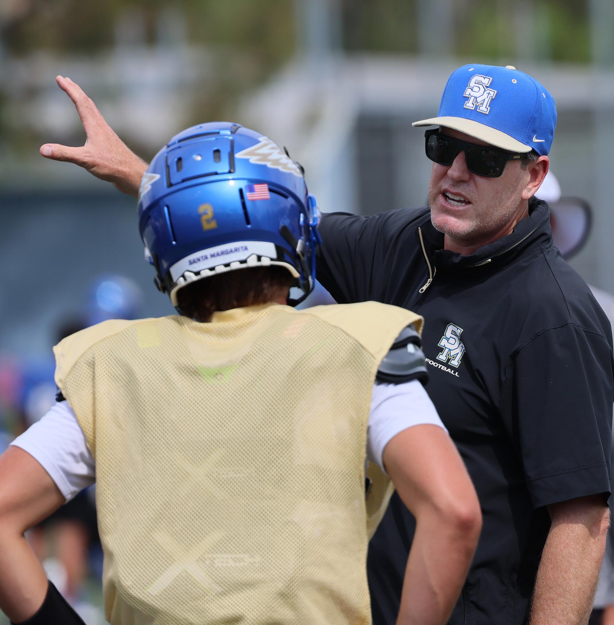 Santa Margarita coach Carson Palmer instructs a player during practice.