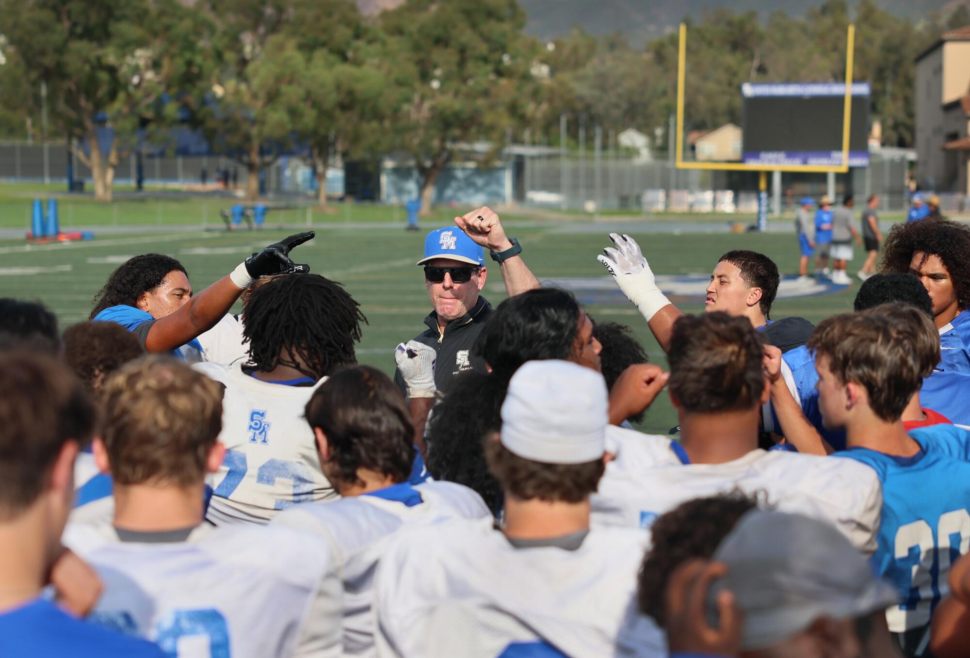 Santa Margarita coach Carson Palmer speaks to his players during practice on Wednesday.