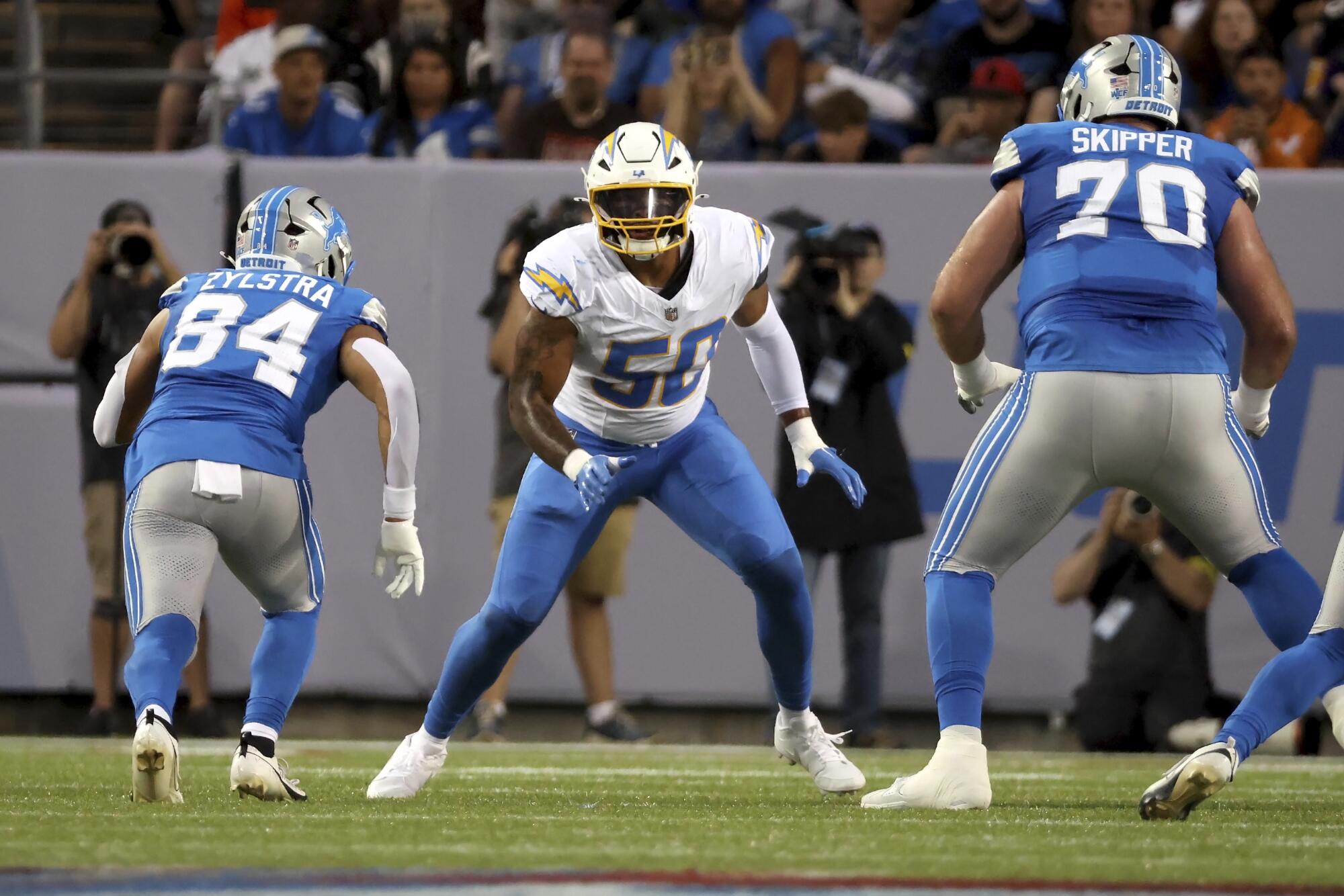 Chargers linebacker Caleb Murphy runs after the ball during a preseason game against the Detroit Lions.