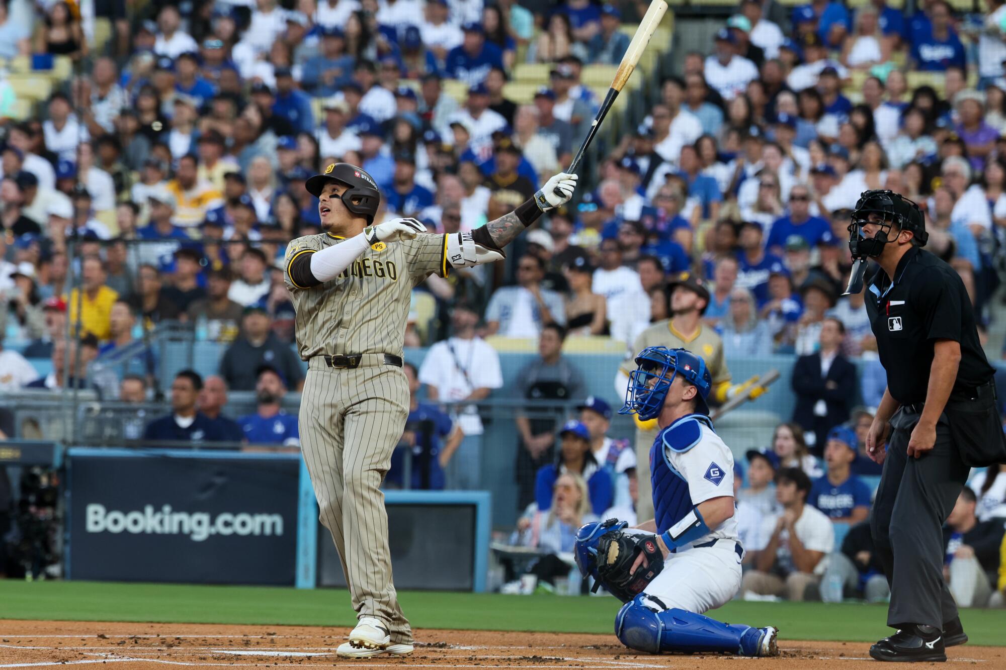 The Padres' Manny Machado follows through on a two-run home run in Game 1 of the 2024 NLDS against the Dodgers.