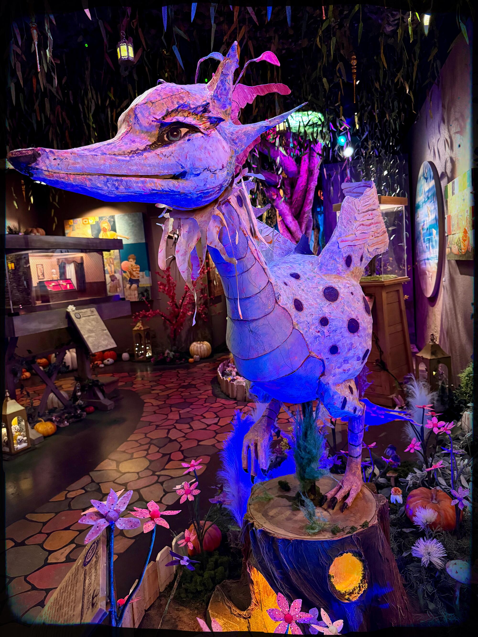 A cheerful dragon greets guests inside the Museum of Make Believe.