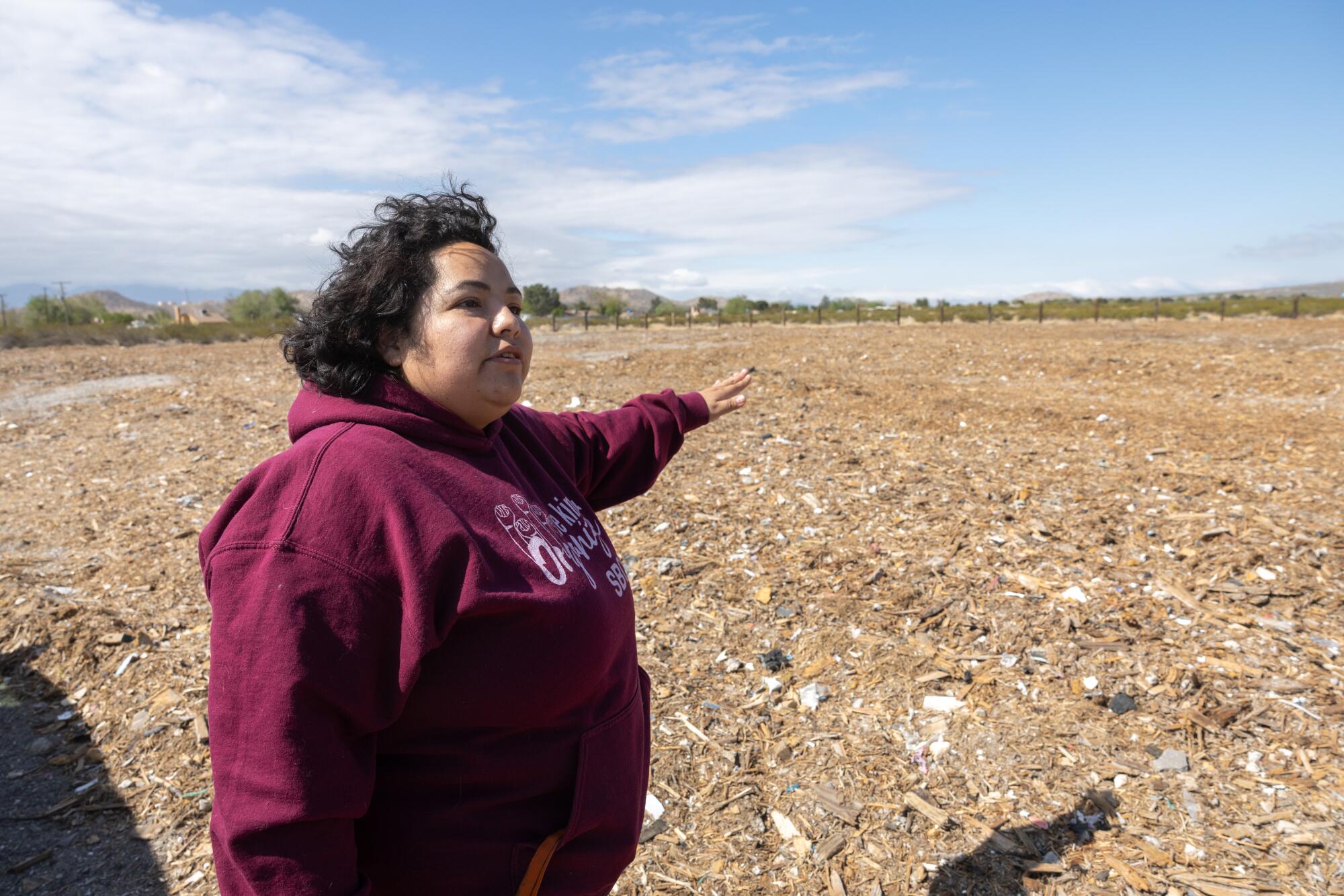 Erika Schwerdt, community organizer, shows an illegal mulch dump in Lake Los Angeles.