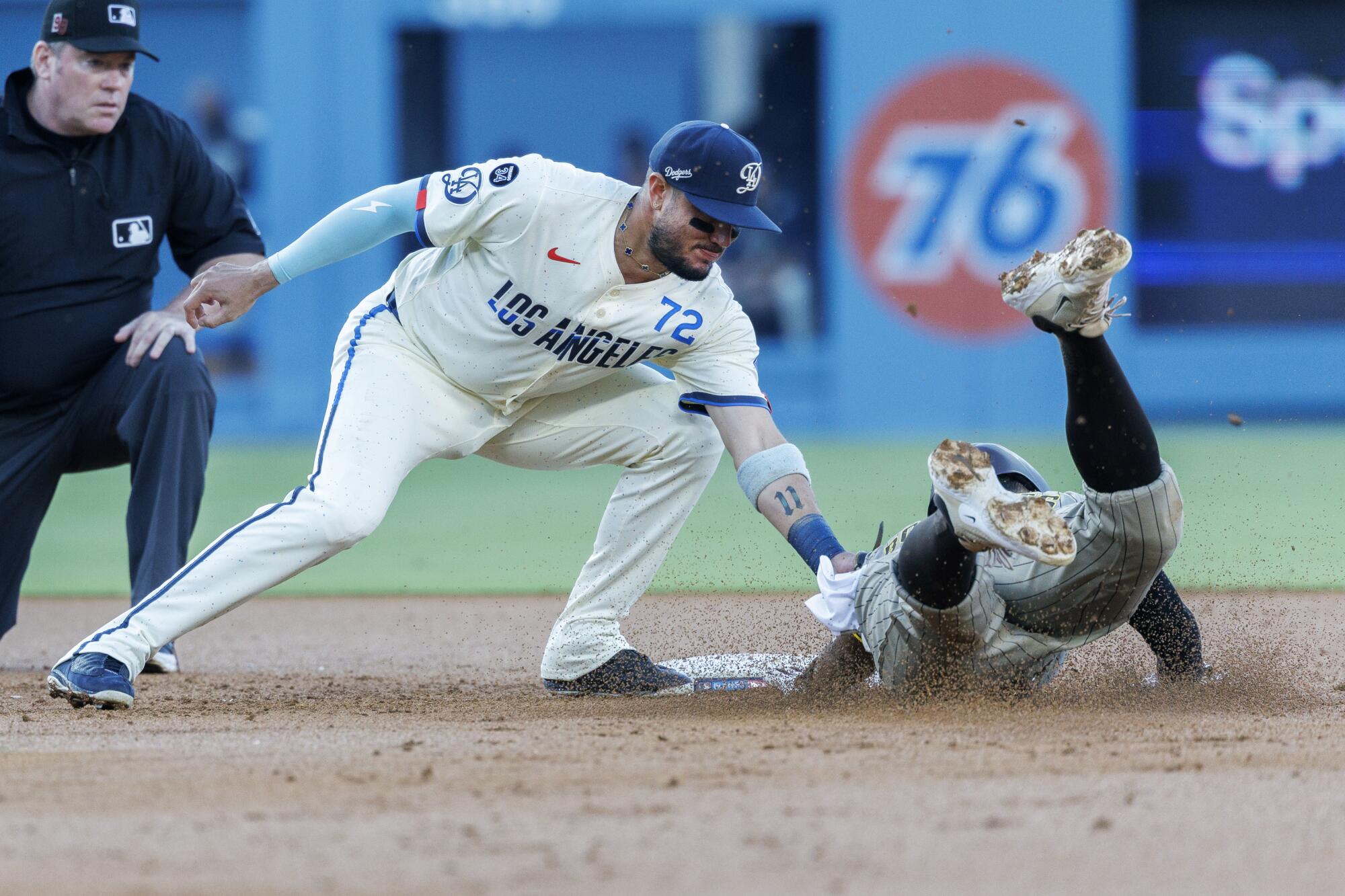 Dodgers second base Miguel Rojas tags out San Diego Padres shortstop Xander Bogaerts.