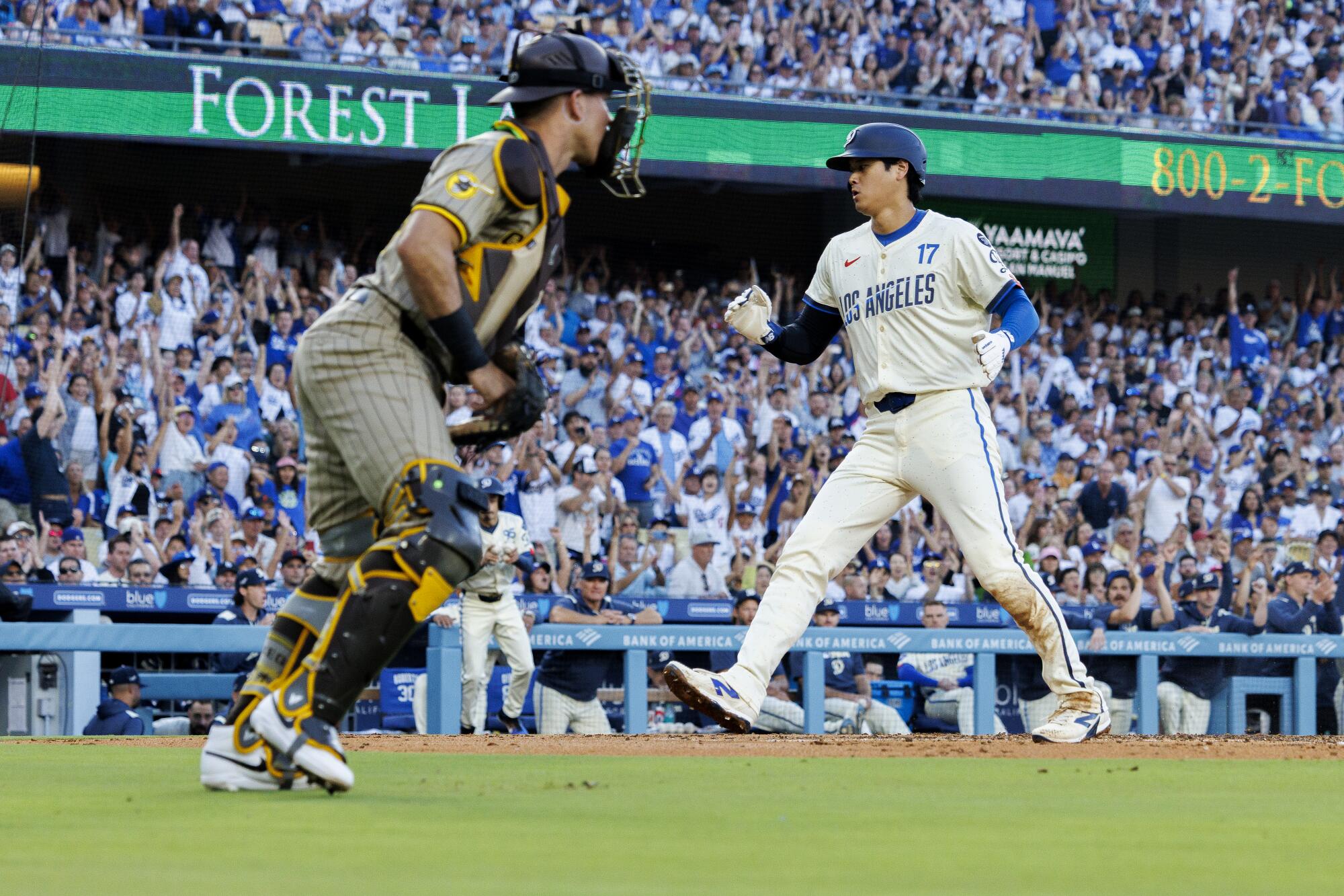 Dodgers star Shohei Ohtani scores on a sacrifice fly in the first inning Saturday against the Padres.
