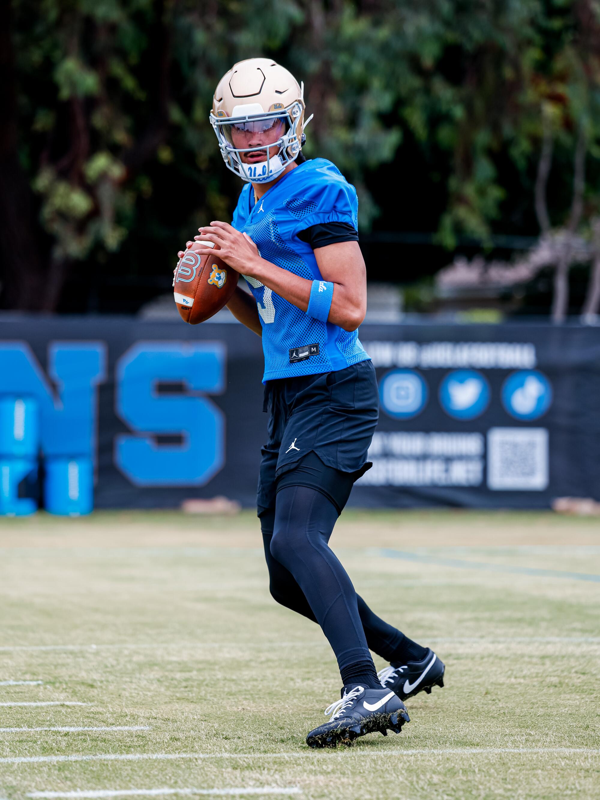 UCLA quarterback Nico Iamaleava grips the ball and looks to pass the ball during the Bruins' preseason camp.